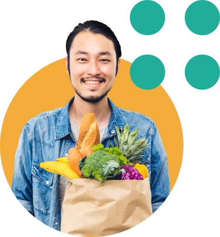Showcase your bank or credit union’s Social Responsibility and Community Engagement within your Digital Banking Solutions (online banking or mobile banking app) to appeal to Gen Z account holders. Image features a smiling young man holding a bag of fresh groceries.