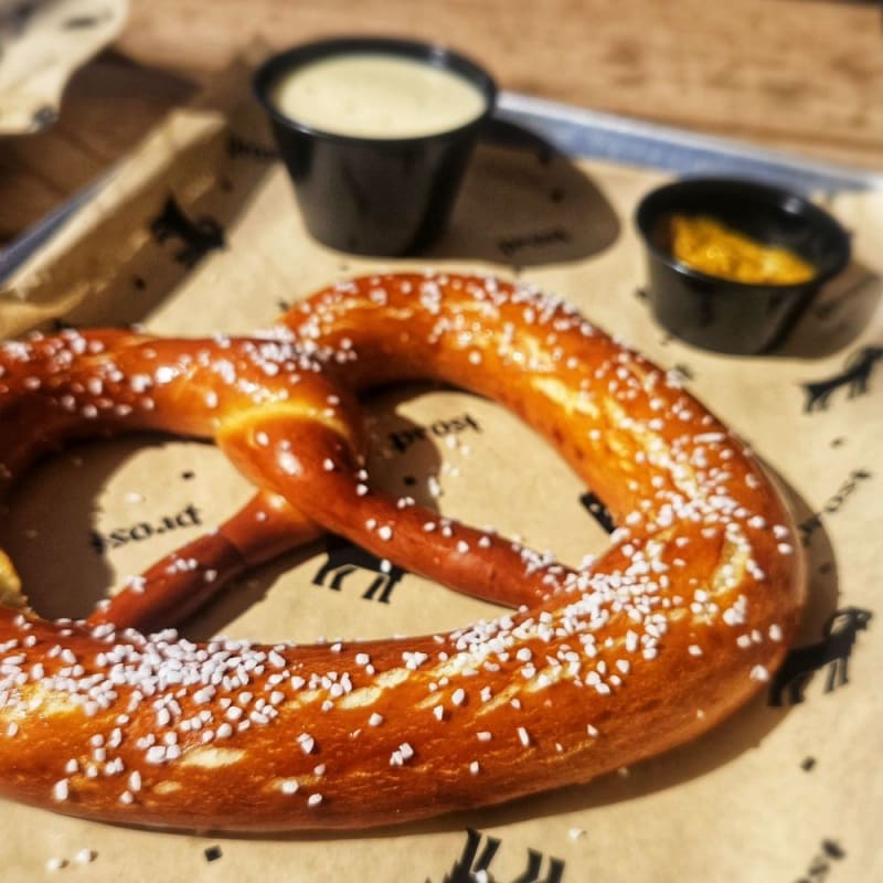 Giant pretzels, steins of beer, and sausages served in festive, communal settings.