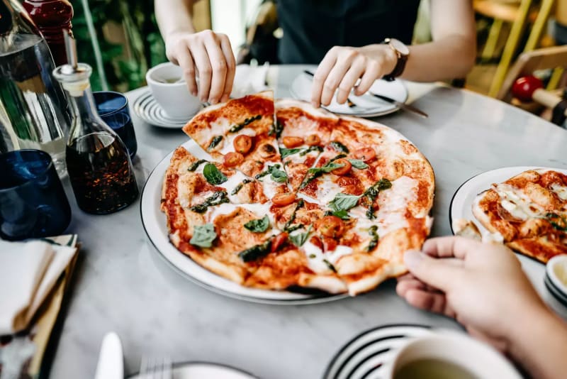 From wood-fired Neapolitan to crispy tavern-style, these pizza joints are local legends.