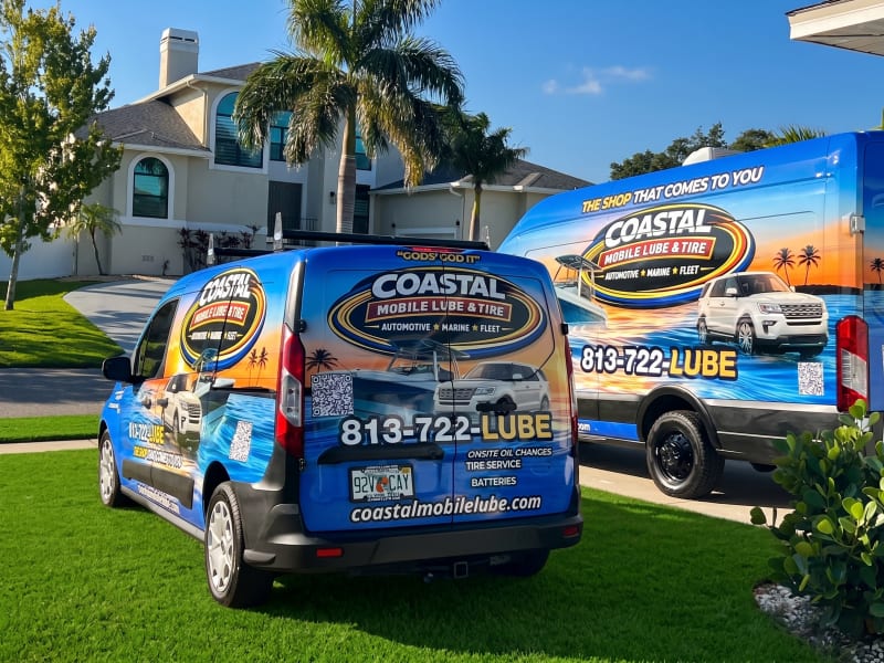 Coastal vans in a residential driveway under palms