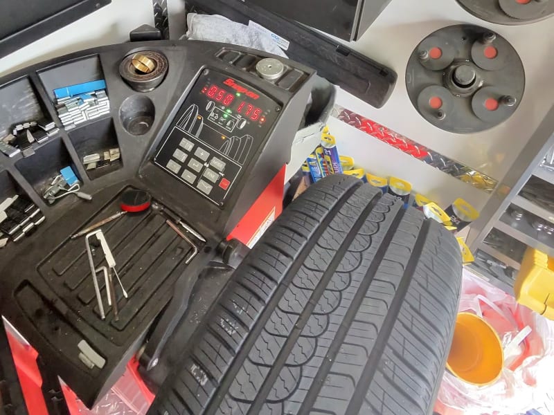 Tire on the Snap-on balancer inside the Coastal service van