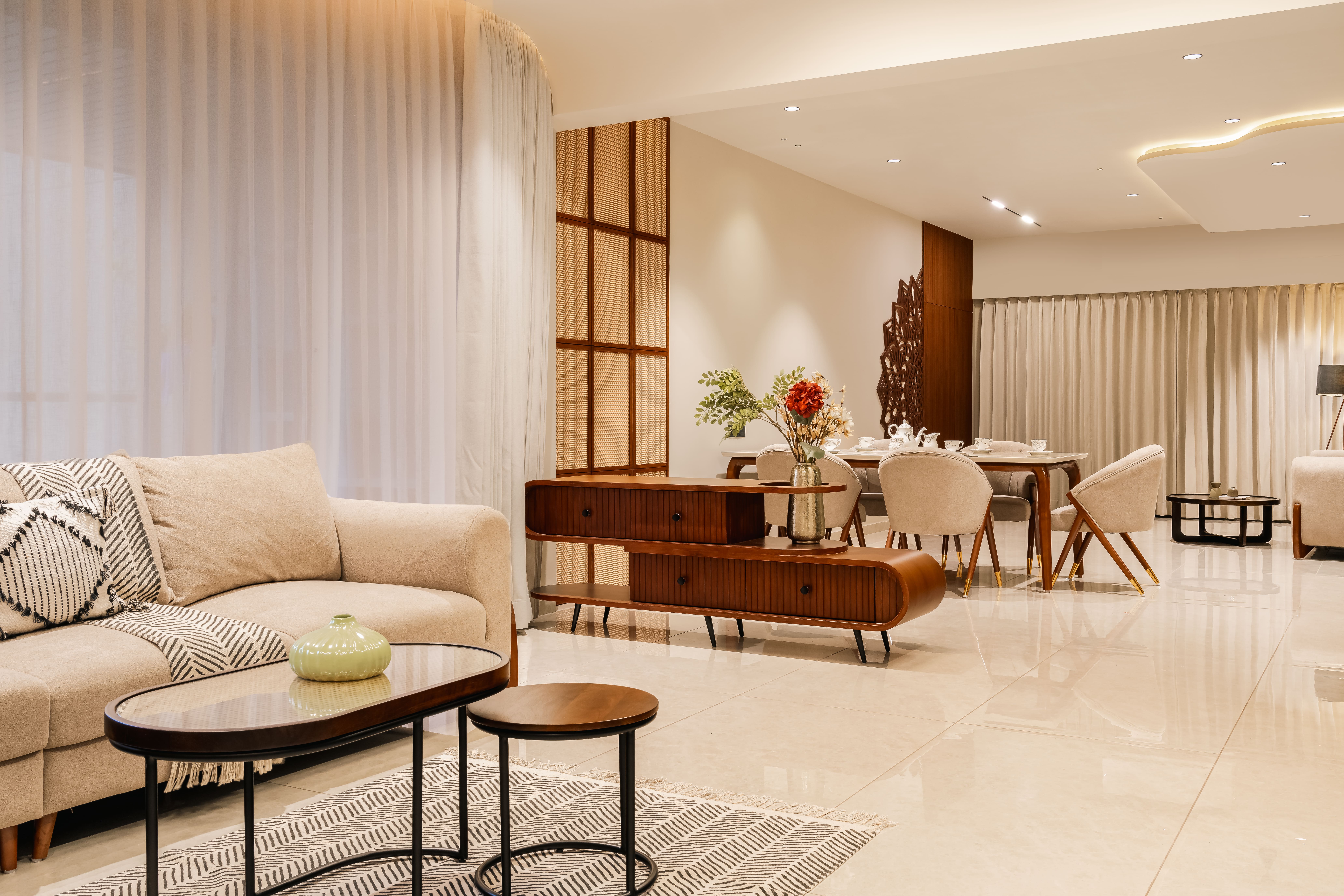 Transformed elegant living room with cream walls, warm sconces, low timber furniture, and curated neutral palette