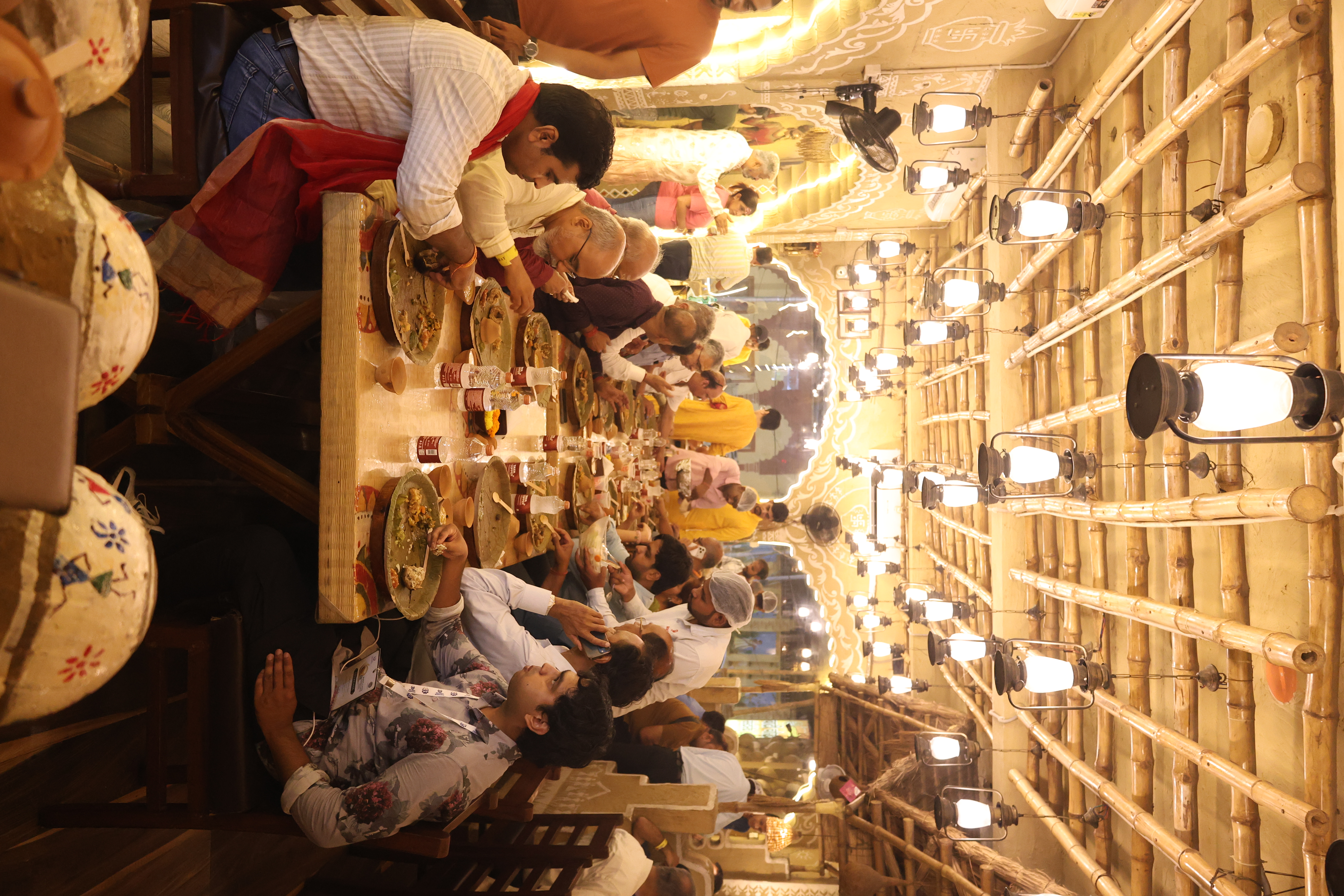The candlelit dining hall of New Theth Banarasi Baati cokha with hand-painted arches