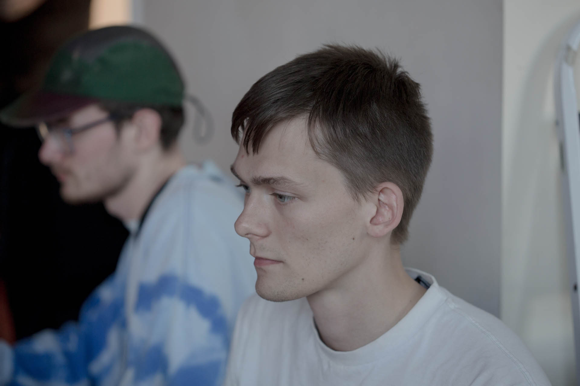 Two males look at their computers off camera