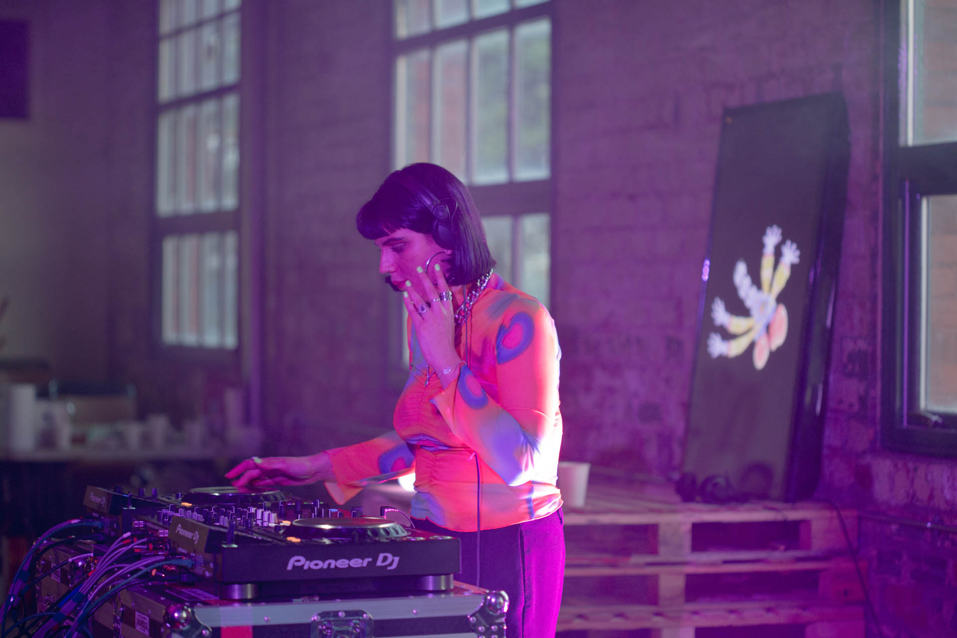 Female DJ with yellow top works the decks