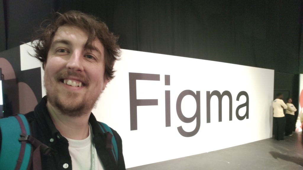 Me smiling with a big sign that says Figma