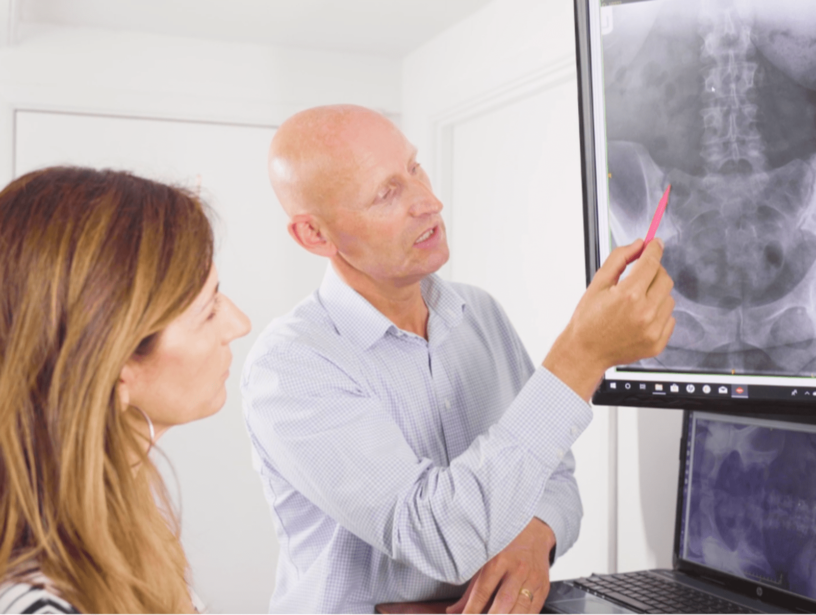 Chiropractor explaining X-Ray findings to a patient at BritChiro New Milton