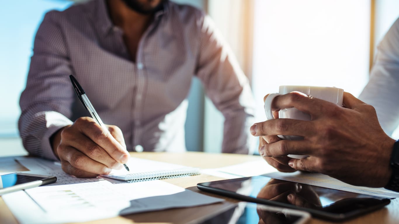 Recruiter taking notes at a desk while the system handles outreach