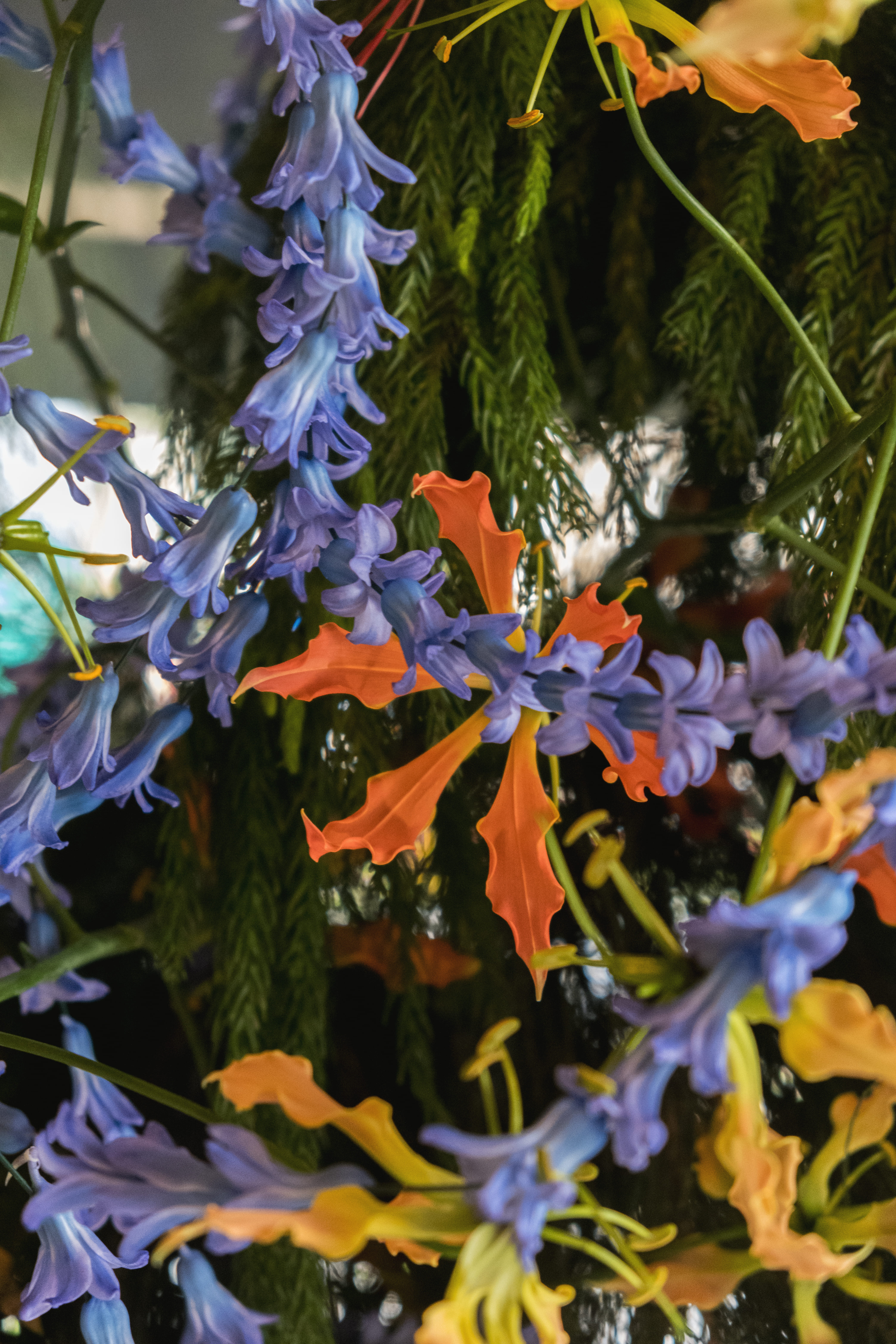 Close-up texture of a blue delphiniums and gloriosa lilies arrangement