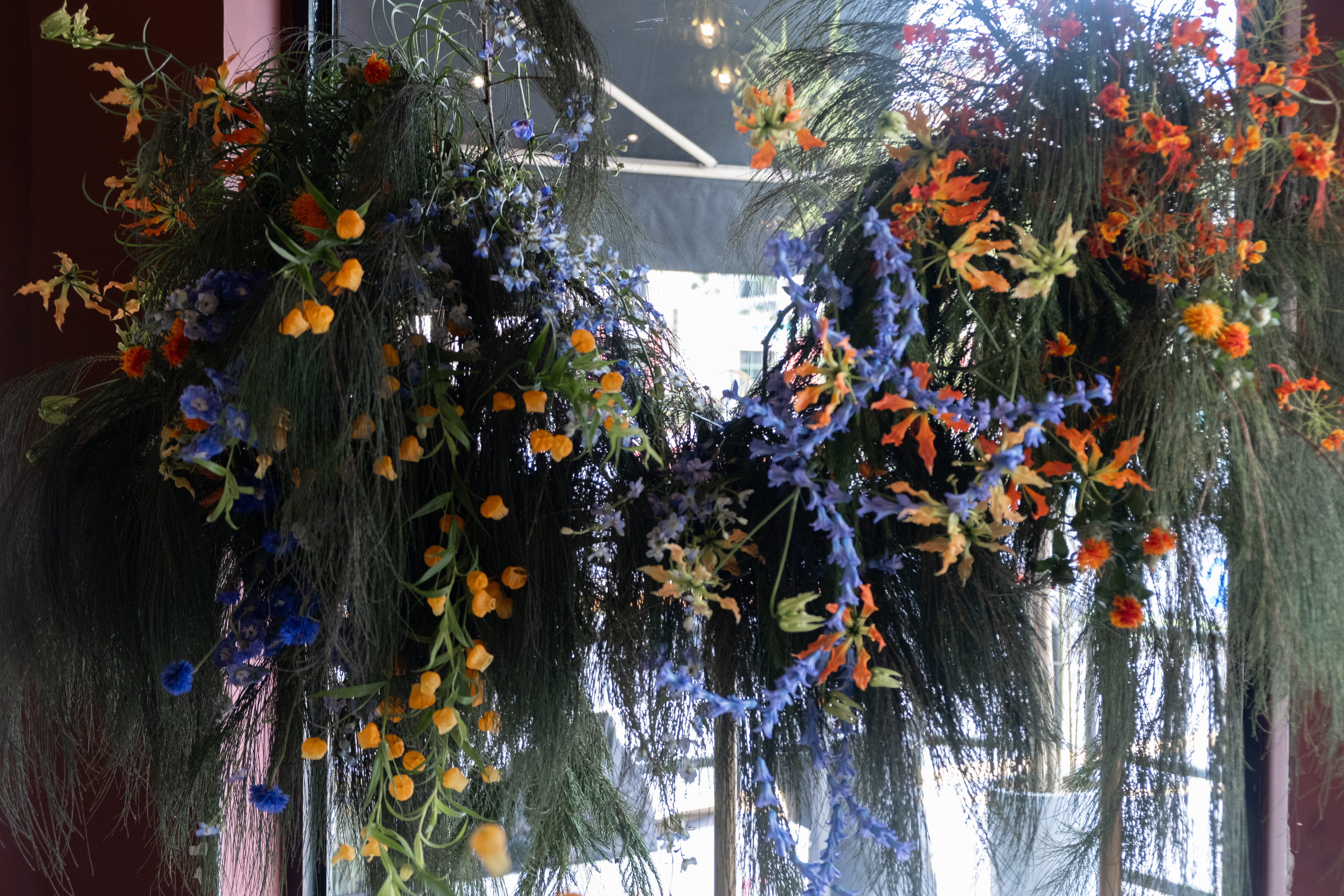Backdrop floral setup with mix of orange and blue.