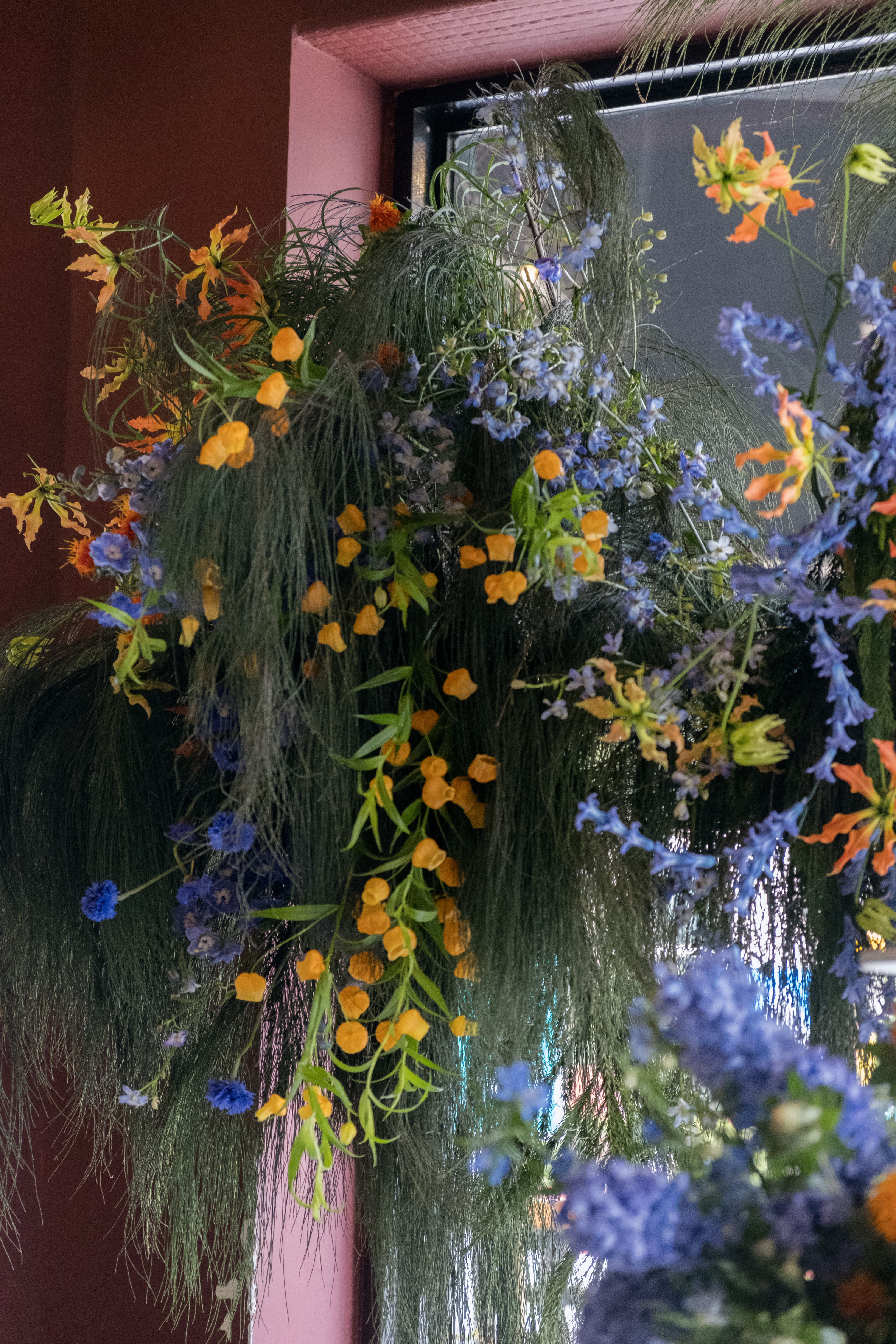 Half side backdrop floral installation with soft lighting.