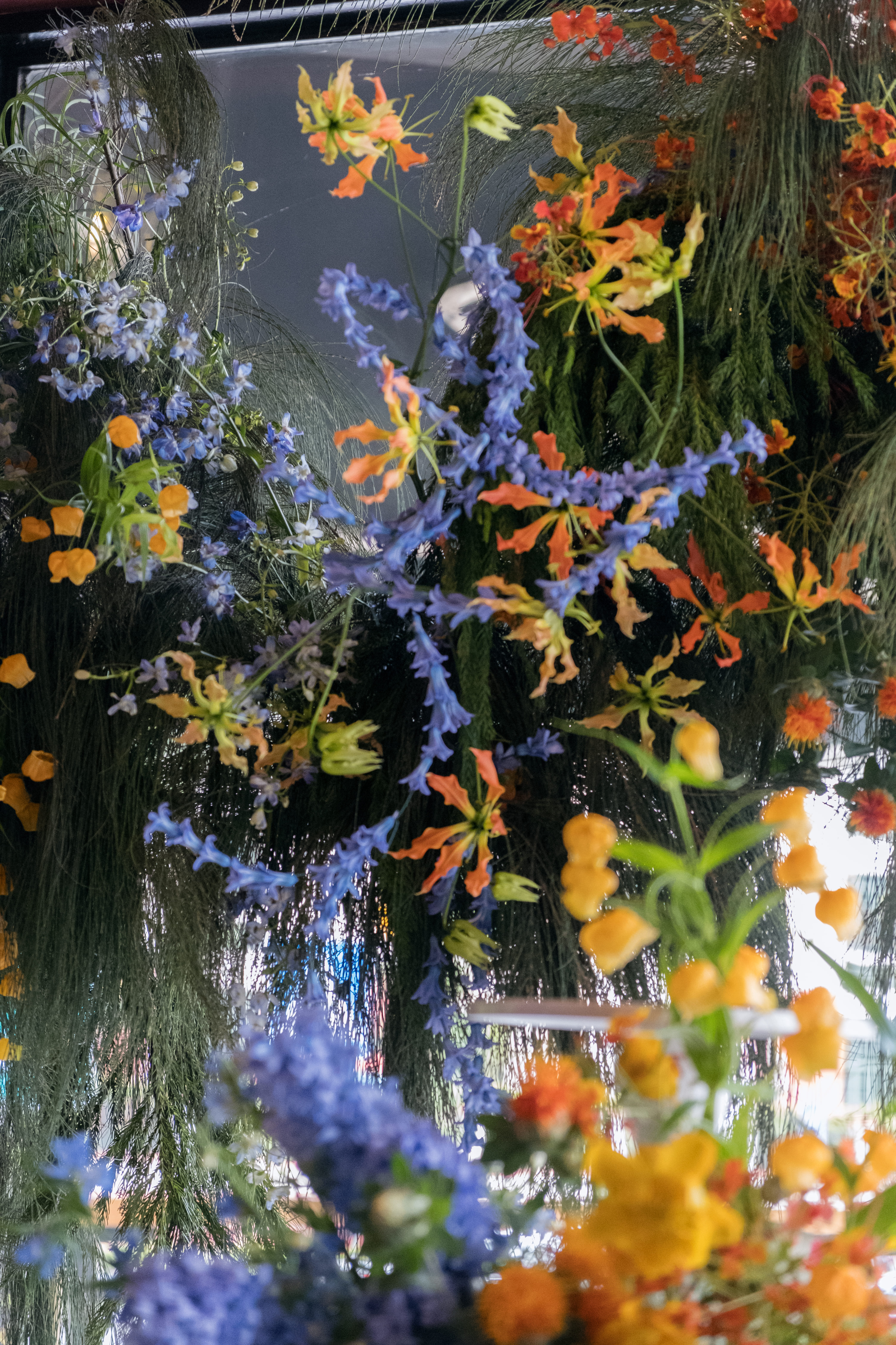 Bold floral installation with orange and blue flowers.