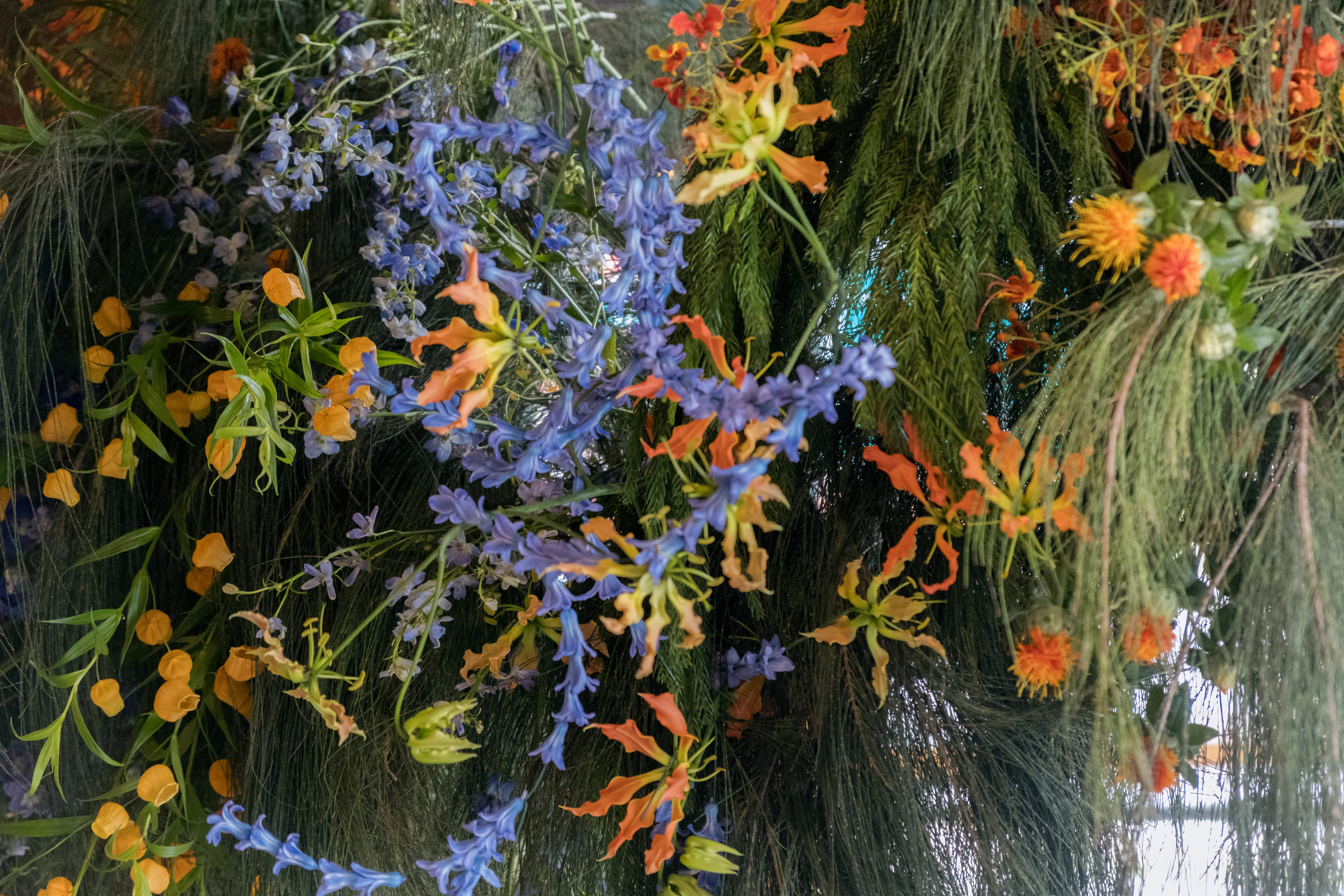 Floral styling with greenery, popping bright blue, orange, and yellow for a birthday party.