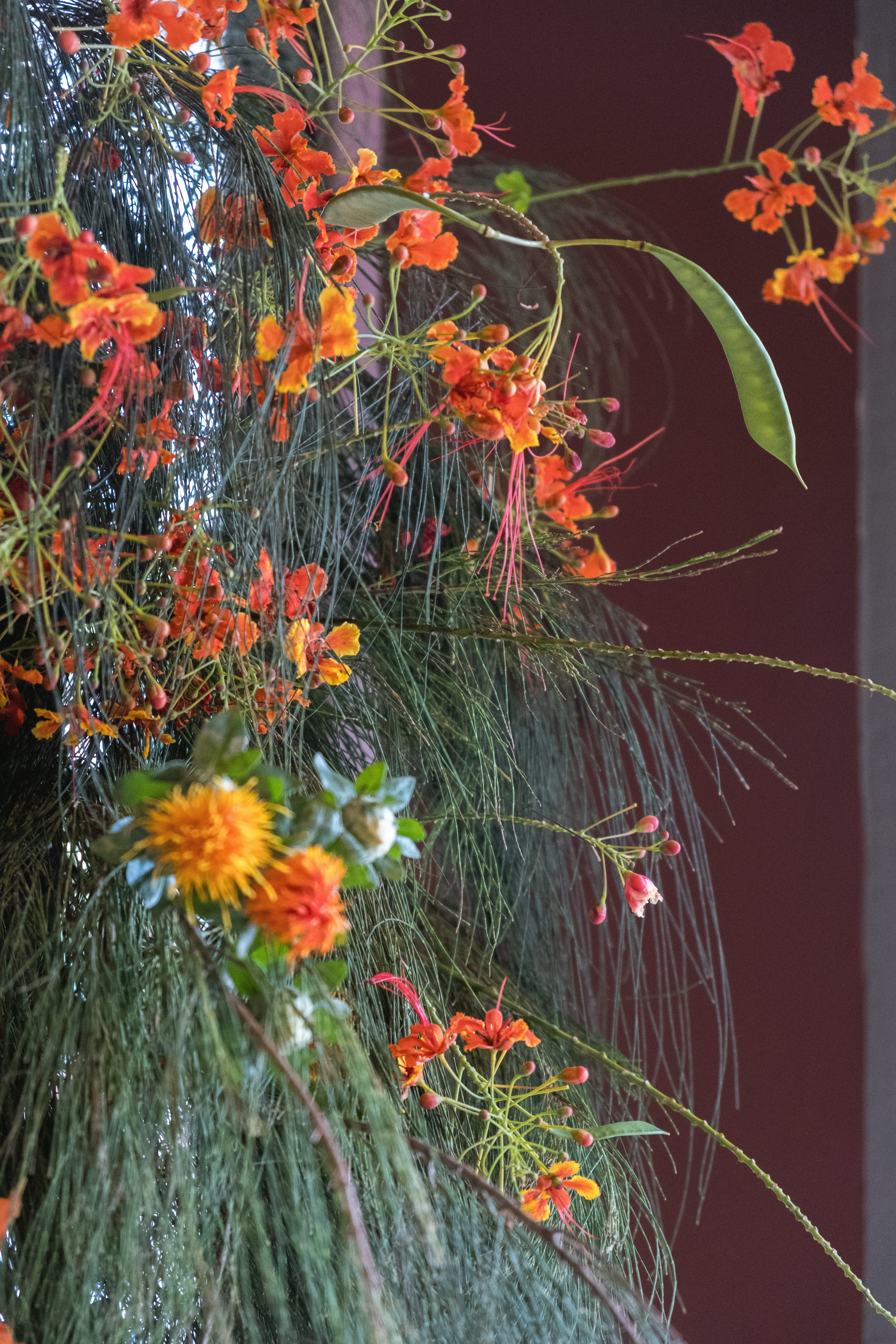 Soft orange cascading florals with greenery.