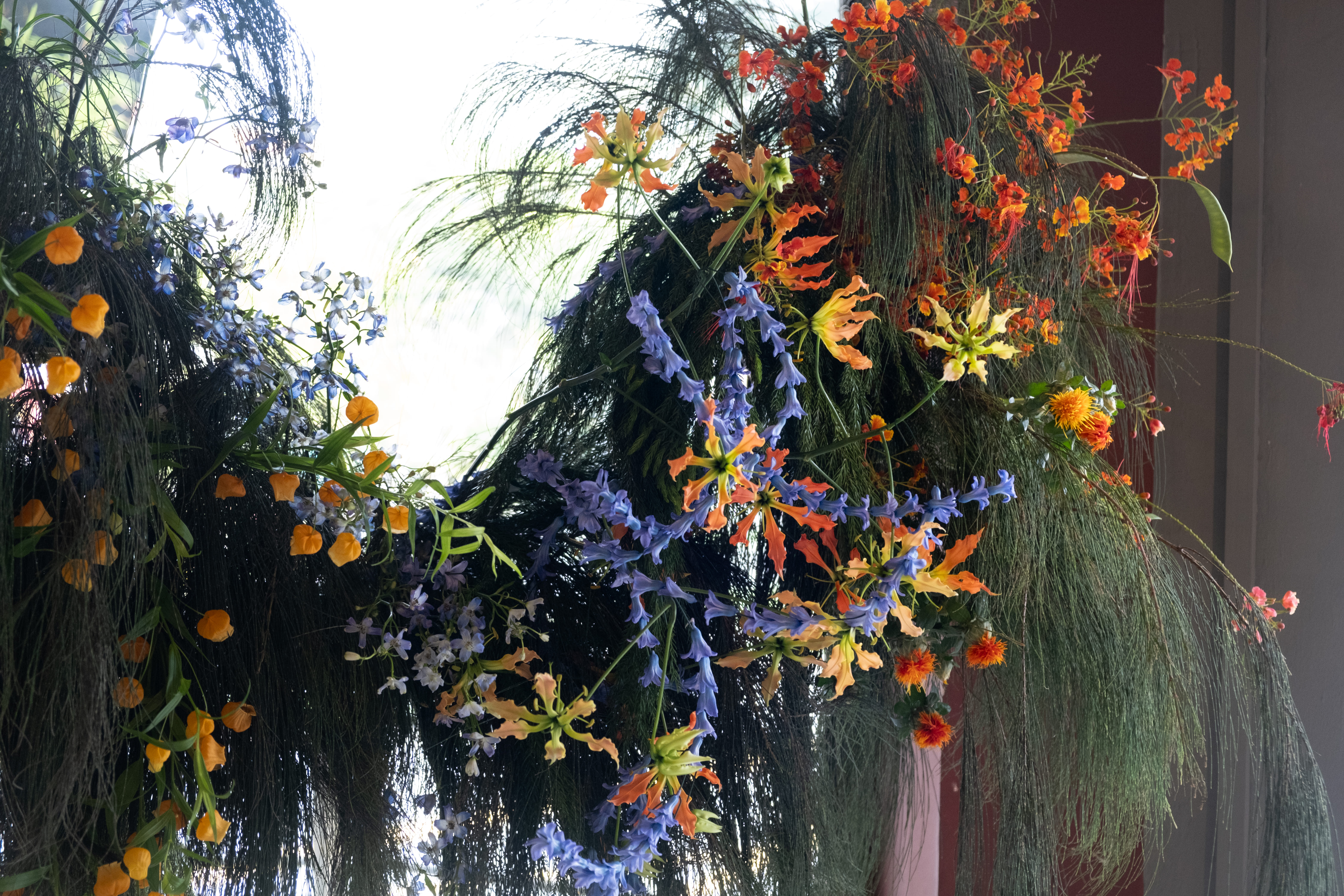 Moody shot of window-side backdrop floral styling.