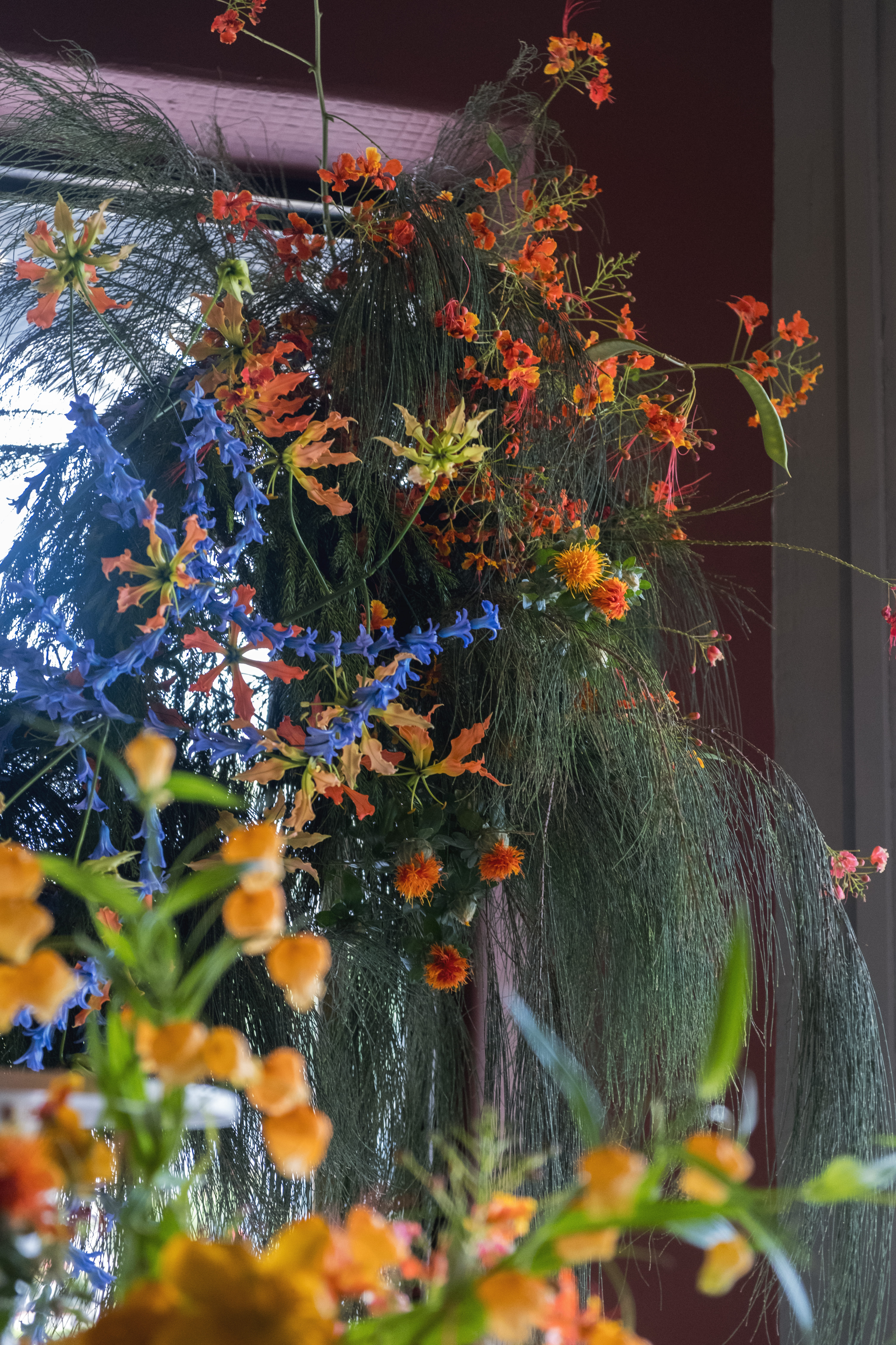 Cinematic shot of backfrop floral cascading by the window with natural light.