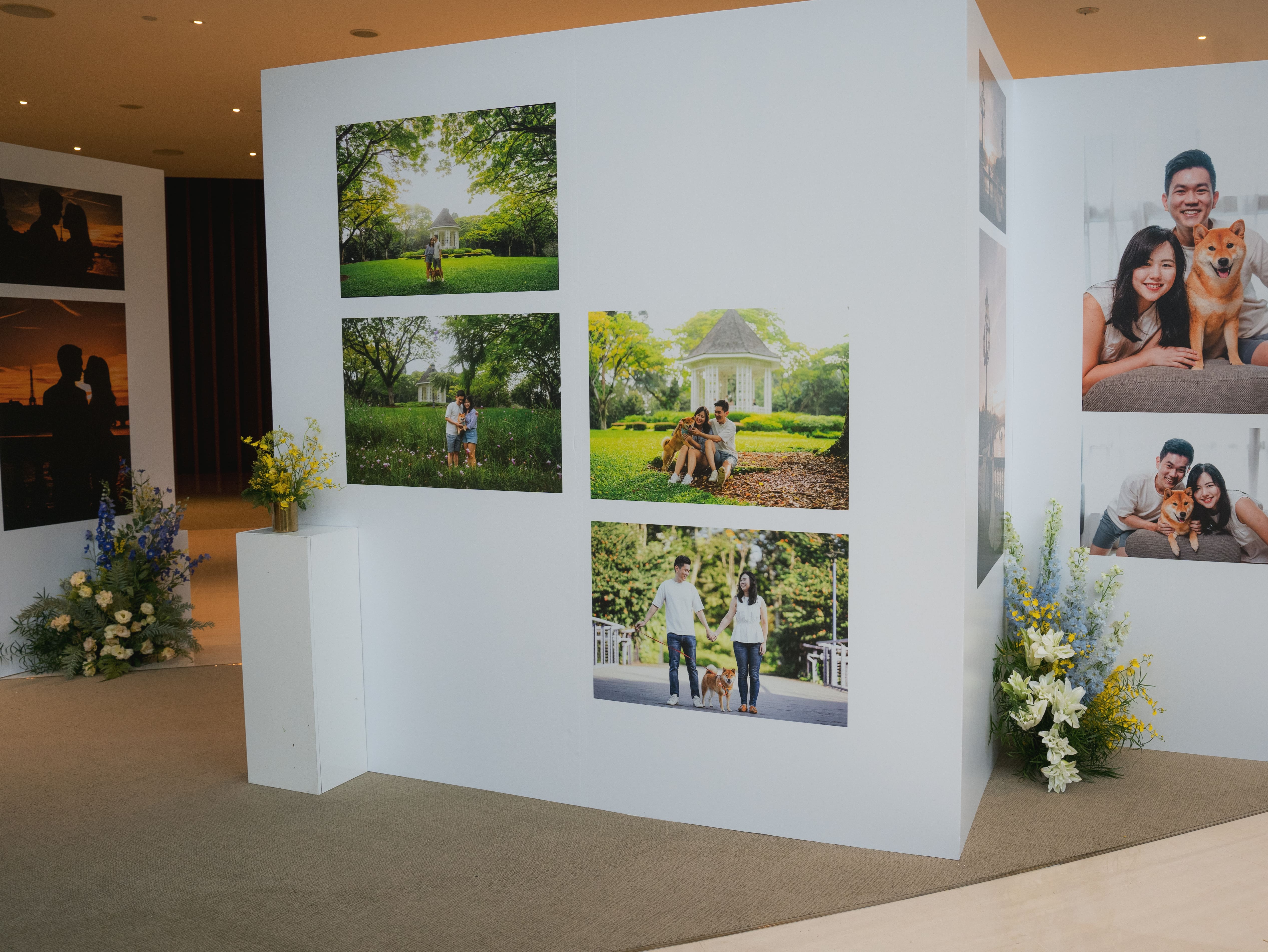 Wide view of photo exhibit with floral touches