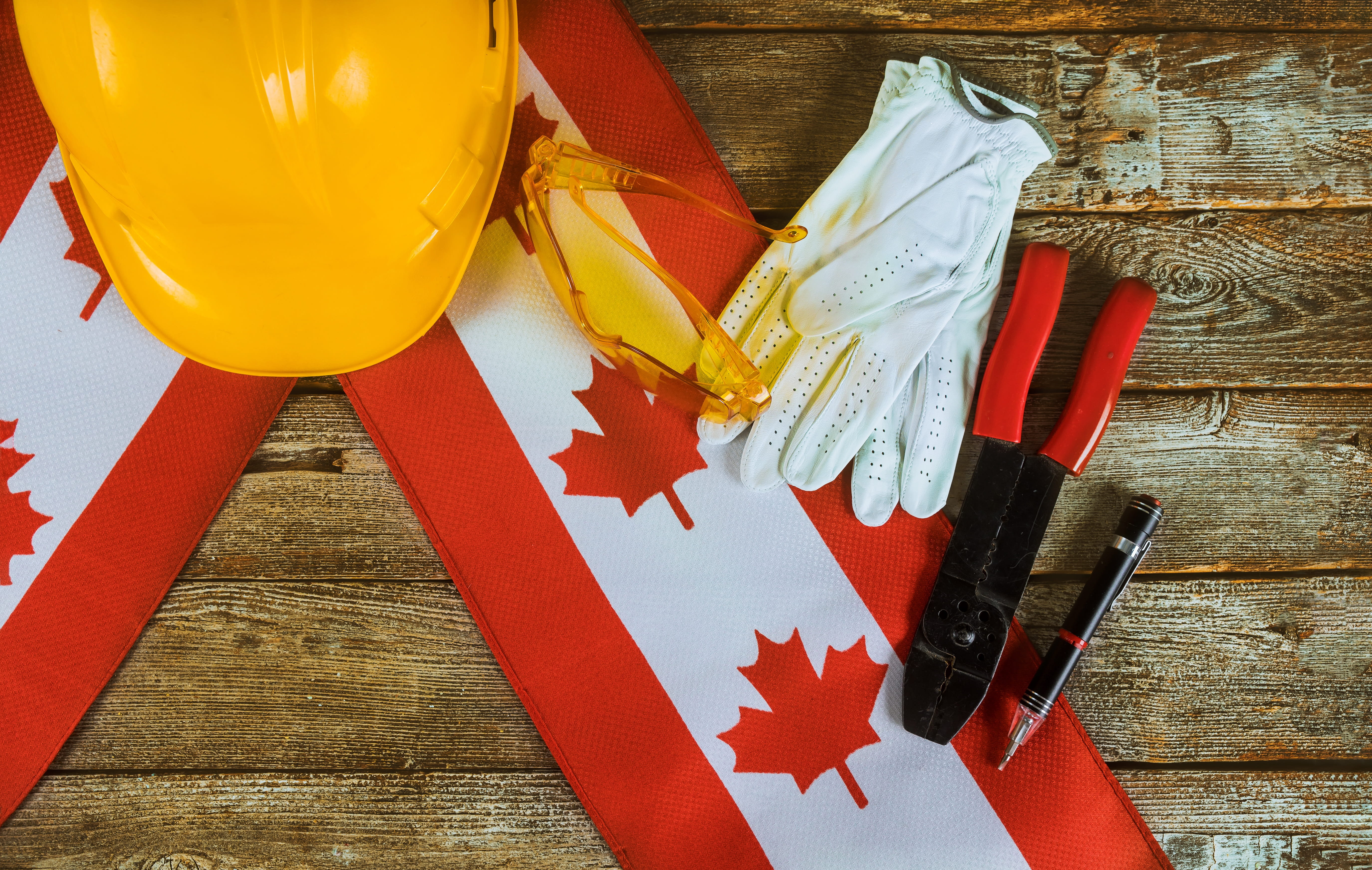 Canadian construction tools and flag