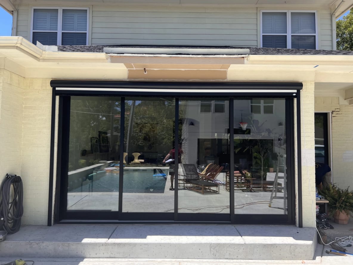 Patio area with sliding glass doors and view of backyard pool
