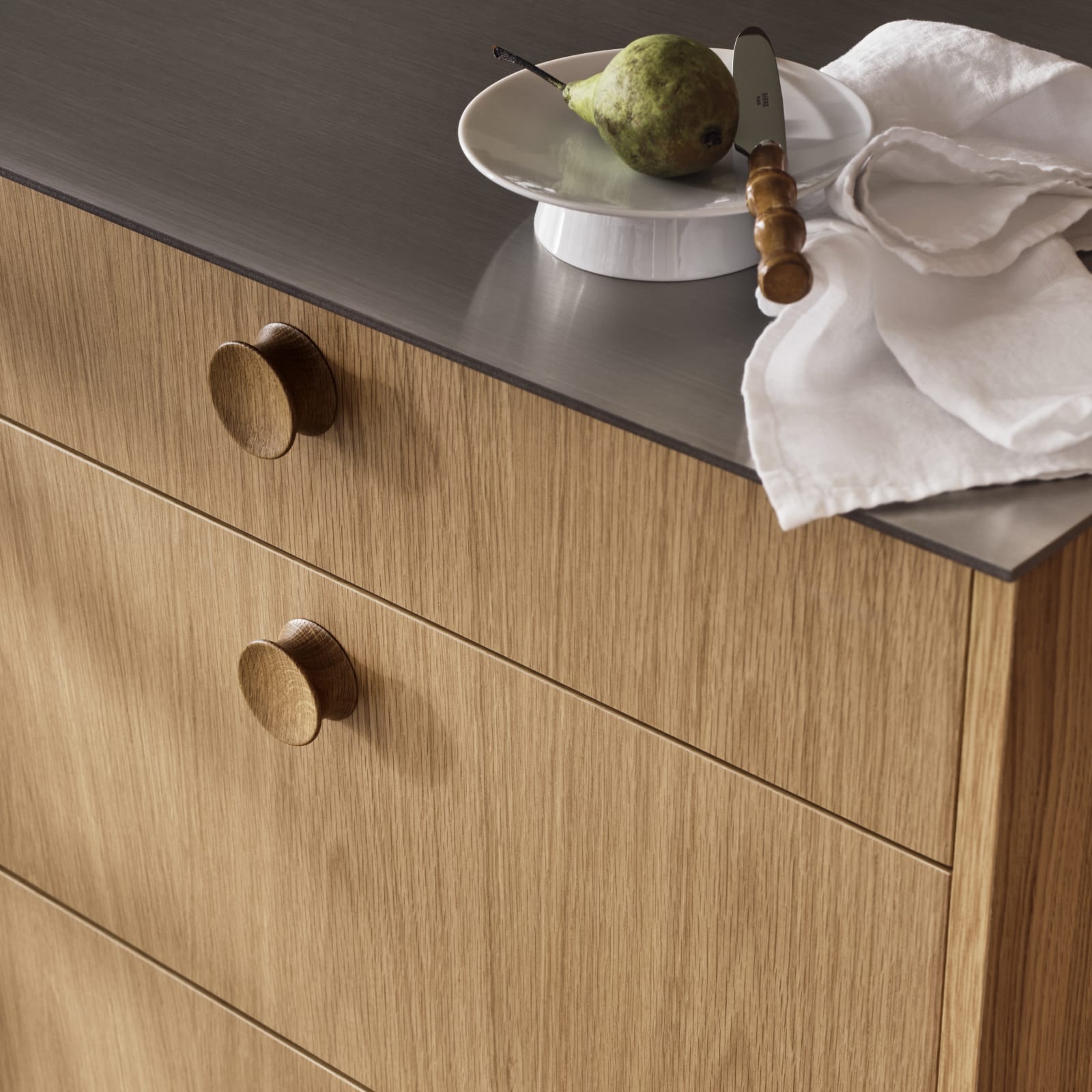 Nærbillede af køkkenlåger eg med eg greb på Jubilæumskøkken fra INVITA med elegant træfinér eg