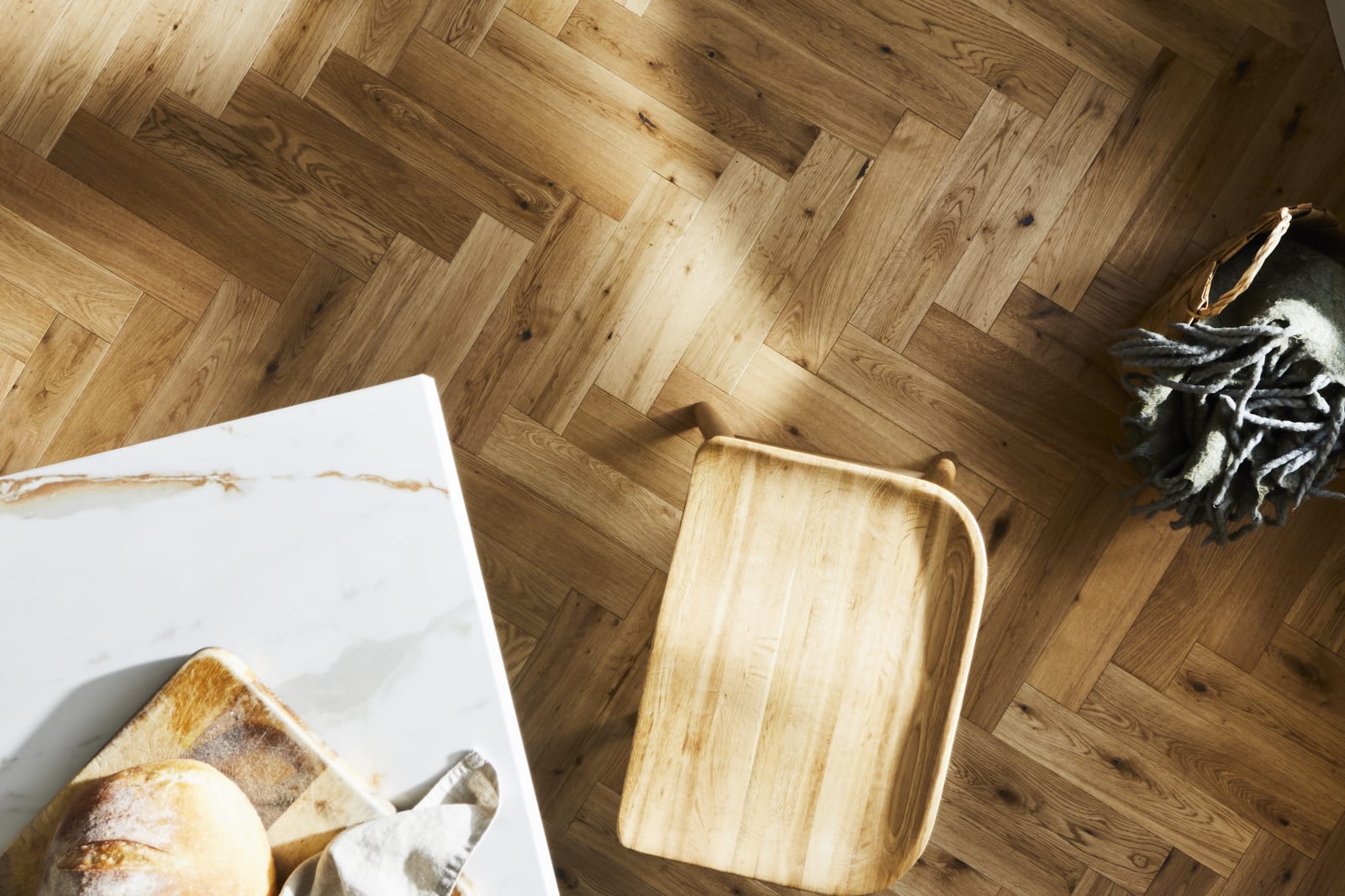 Overhead view of marbled worktop kitchen island corner and the wood floor