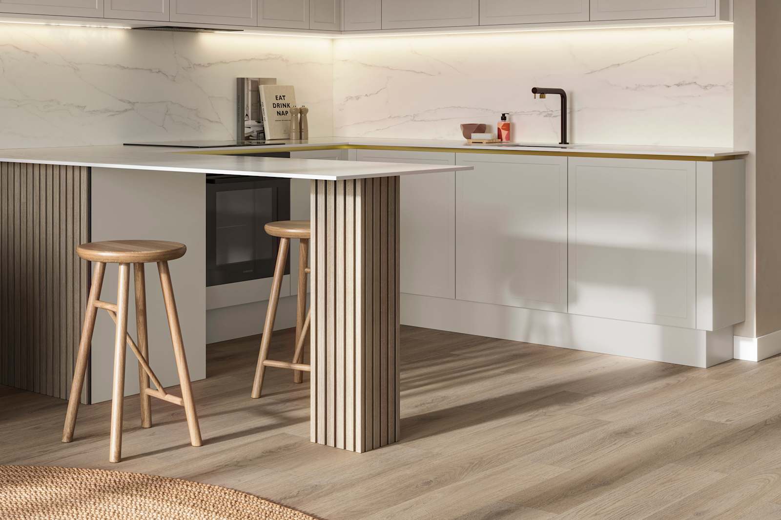 Handleless Wabi sabi inspired Integra Brunswick Limestone kitchen combined with living area, wood barstools for breakfast bar, natural materials, Euros oak flooring.