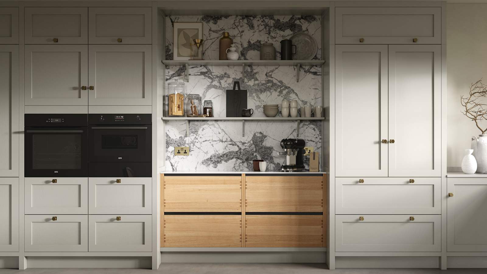 A neutral Shaker kitchen with Pebble and Nordic Craft cabinetry, marble splashback behind open shelves and paired with brass handles.