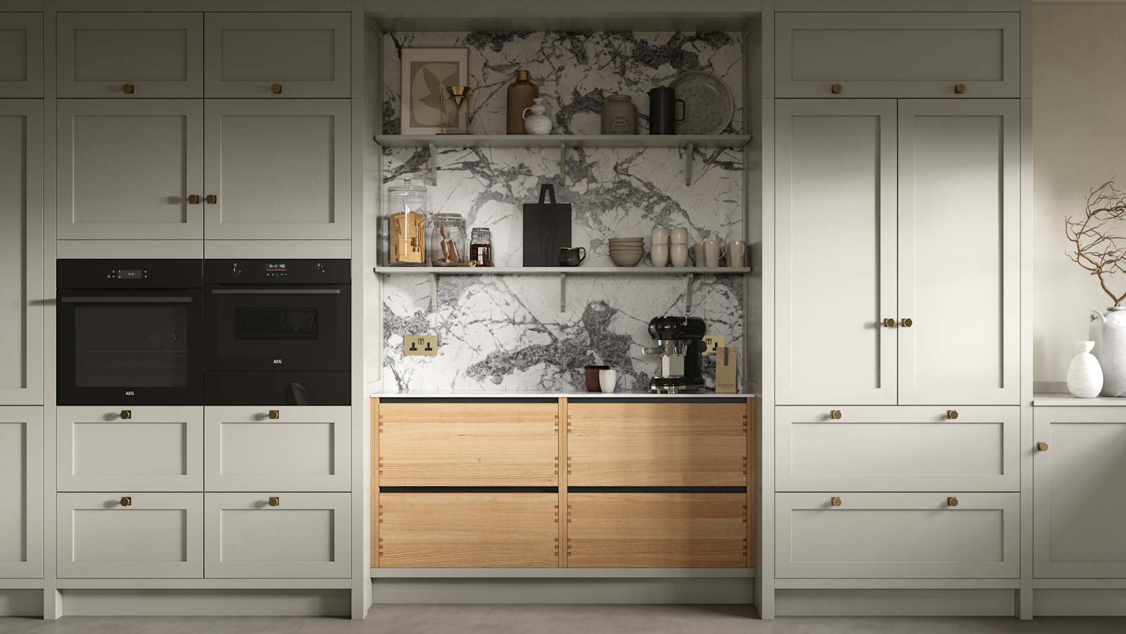 A neutral Shaker kitchen with Pebble and Nordic Craft cabinetry, marble splashback behind open shelves and paired with brass handles.