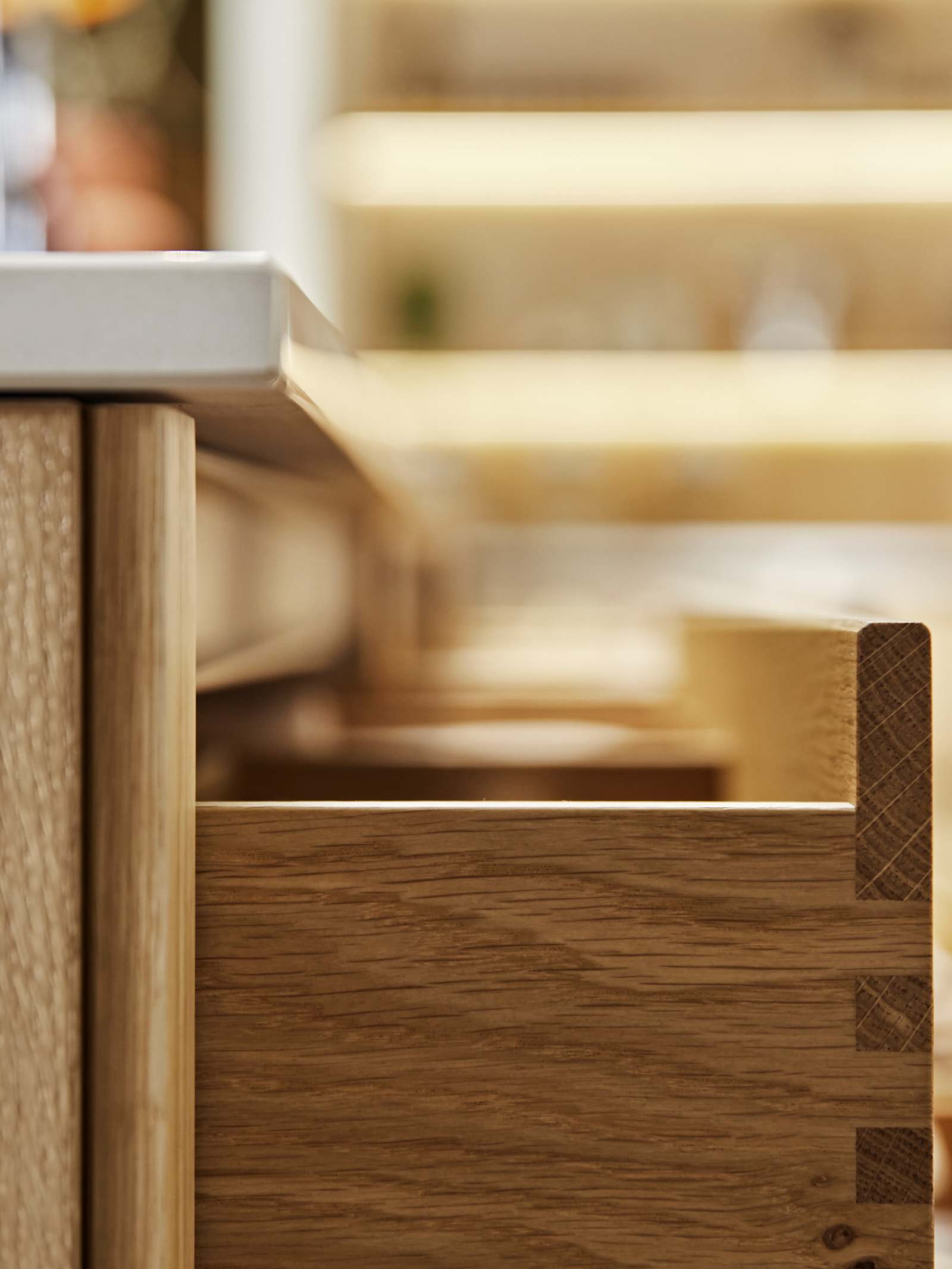 Close-up side view of opened oak drawer in Nordic Craft kitchen island.