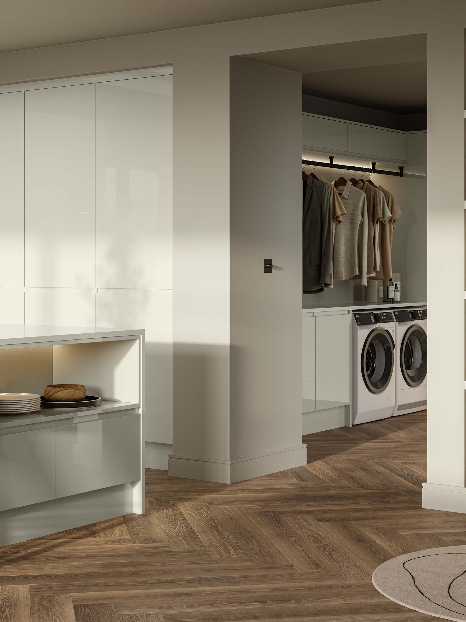 Open plan contemporary Luna Gloss kitchen with a kitchen island, breakfast bar, tall cabinetry, matching open shelves in living room with natural material decorations and utility room with integrated washing machine and tumble dryer, Amtico smouldering oak parquet flooring.