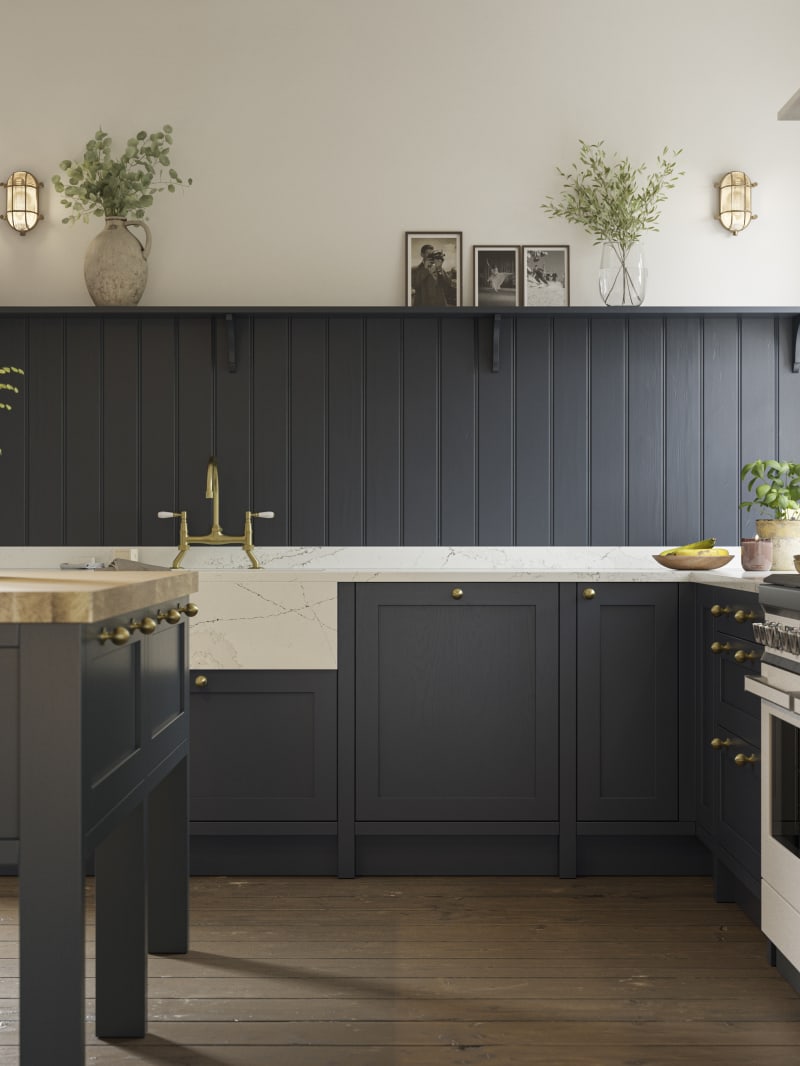 Open floorplan shaker kitchen in the dark blue shade Midnight, with a kitchen island and matching blue painted wood wall panel.