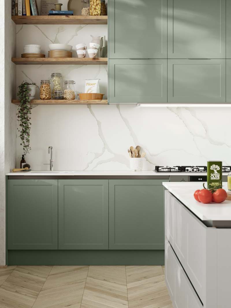 Integra Dunham from Magnet is a handleless shaker frontal, here shown in kitchen with kitchen island and wall cabinets in shades Eucalyptus and Washed Cotton, with a white marbled worktop and matching splashback with wood open wall shelves..