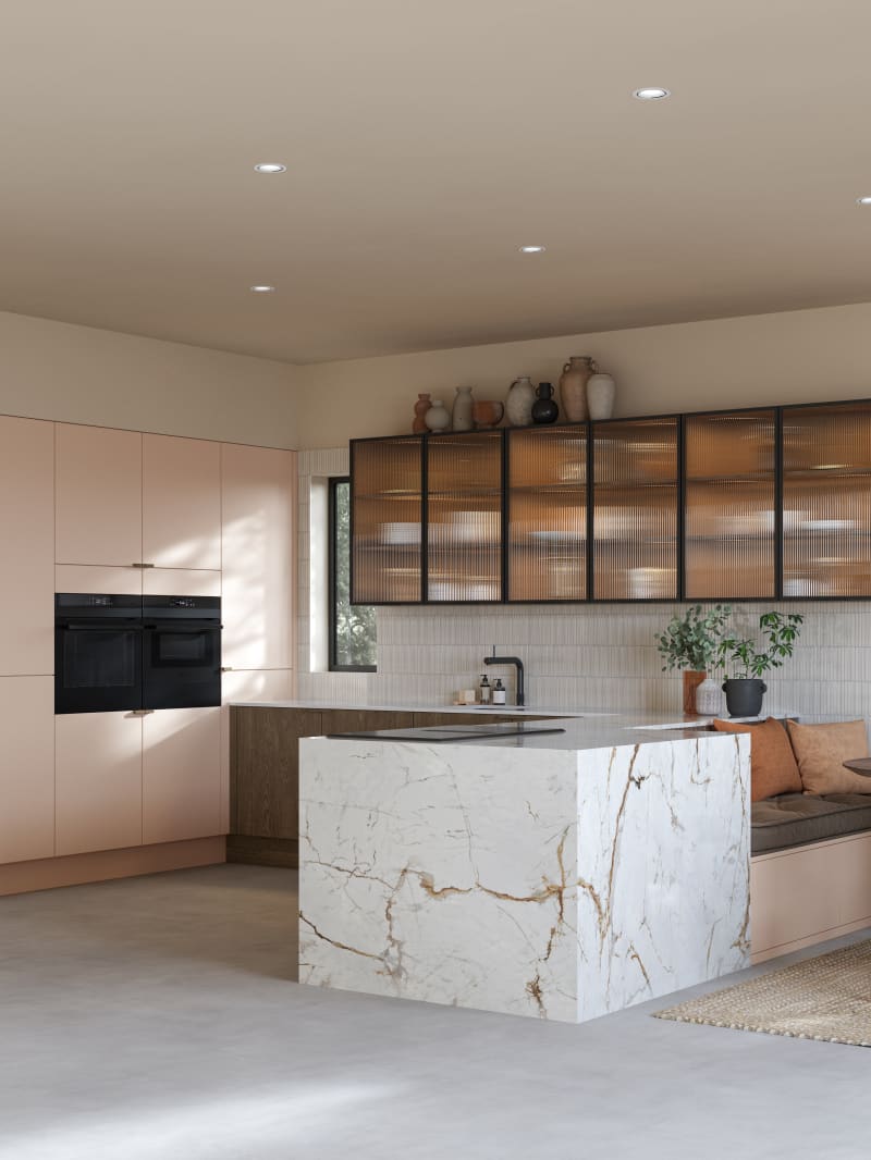 Full room view of open plan kitchen Soho Chalk Blush, matched with fluted glass display cabinets and oak front cabinetry in Nordic Nature.