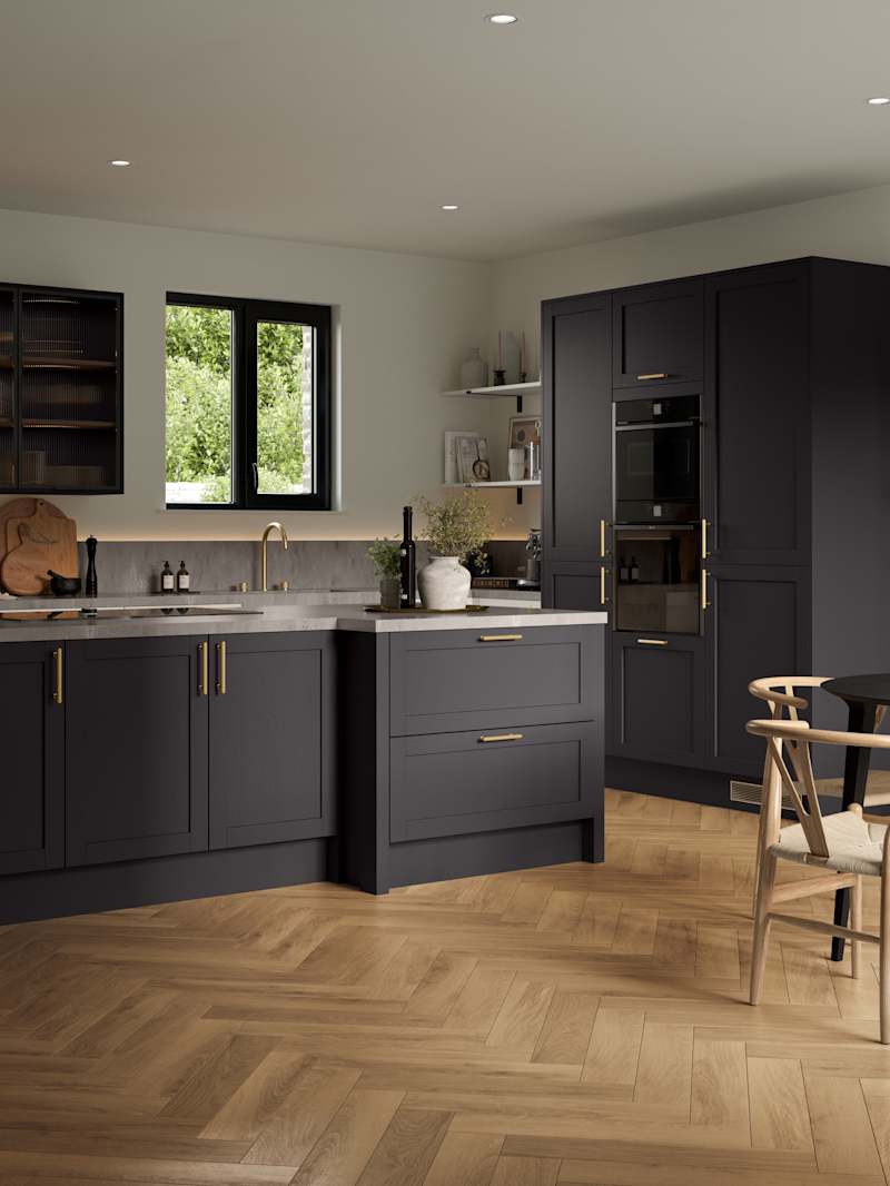 A contemporary Shaker kitchen with black cabinets and hardwood floors, paired with fluted glass cabinets.