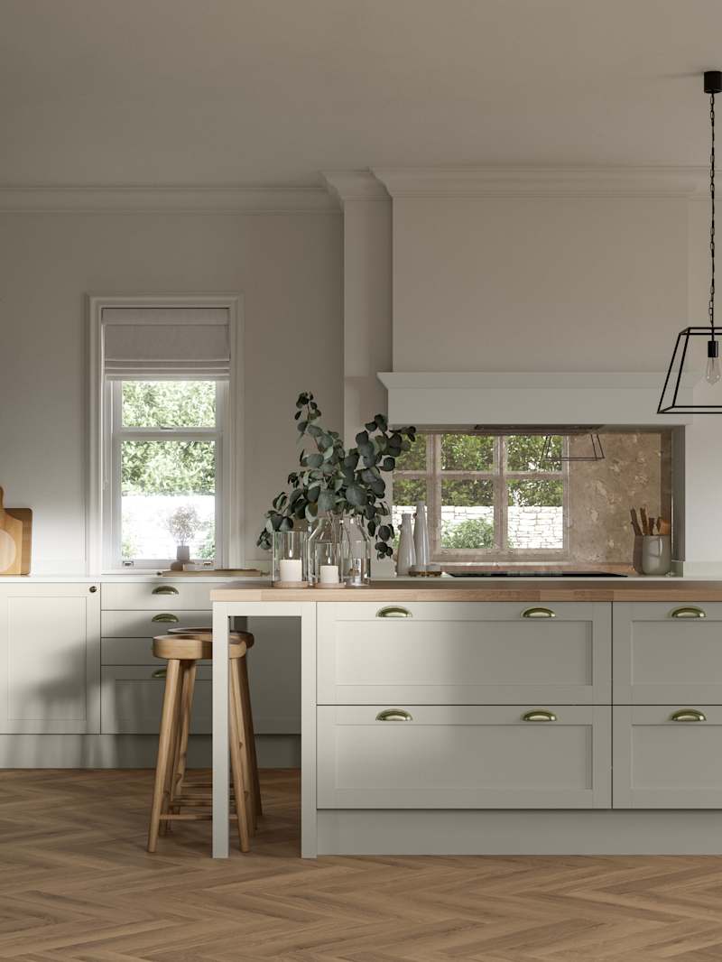Ambleside kitchen range shown in a home kitchen with blue Shaker cabinets and wood floors.