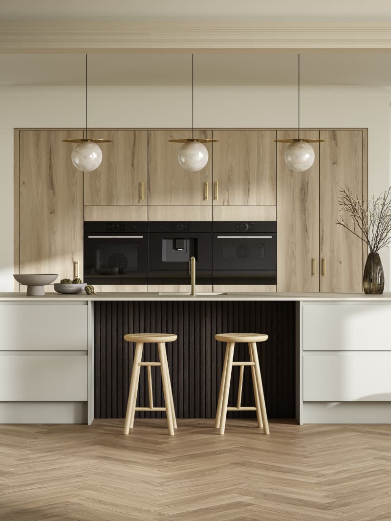 Portobello kitchen cabinets in a light woodgrain are set behind Magnet's Duxbury range in Limestone, creating a light and modern open plan kitchen with a breakfast bar island.