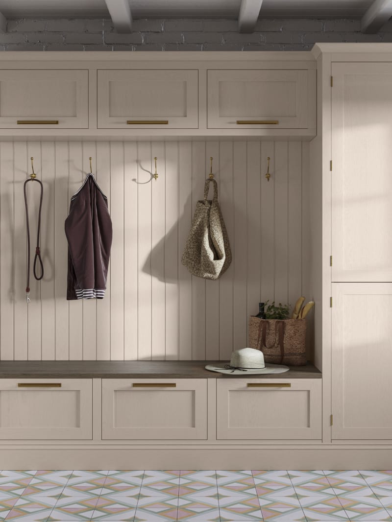 Entrance hallway with Magnet Wardley cabinetry, wall panel, top cabinets and seating bench with large drawers, all matching in the warm light beige shade Shell.