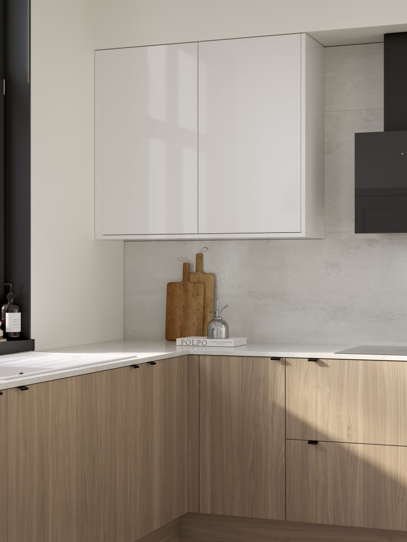 Ascoli kitchen from Magnet with Natural Oak cabinetry, a white worktop, Ascoli Gloss white wall cabinets over countertop paired with matching black handles, tap, hood and window frame over white sink.