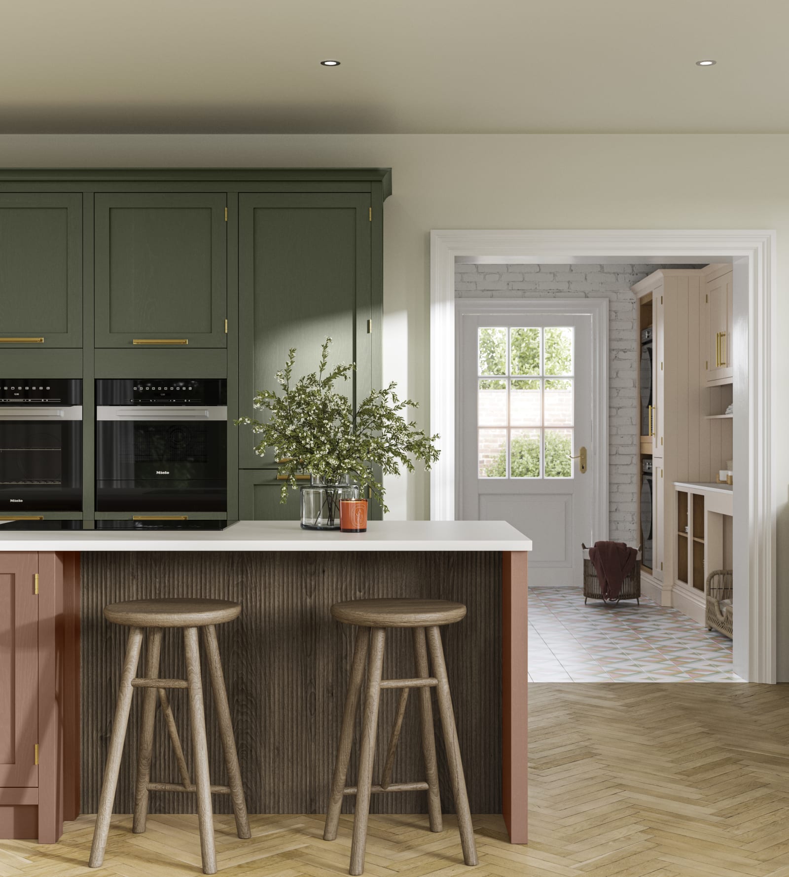Tall Wardley kitchen cabinets  with built-in ovens, a kitchen island in shade Clay with wooden panelling by seating area and matching wooden bar stools.