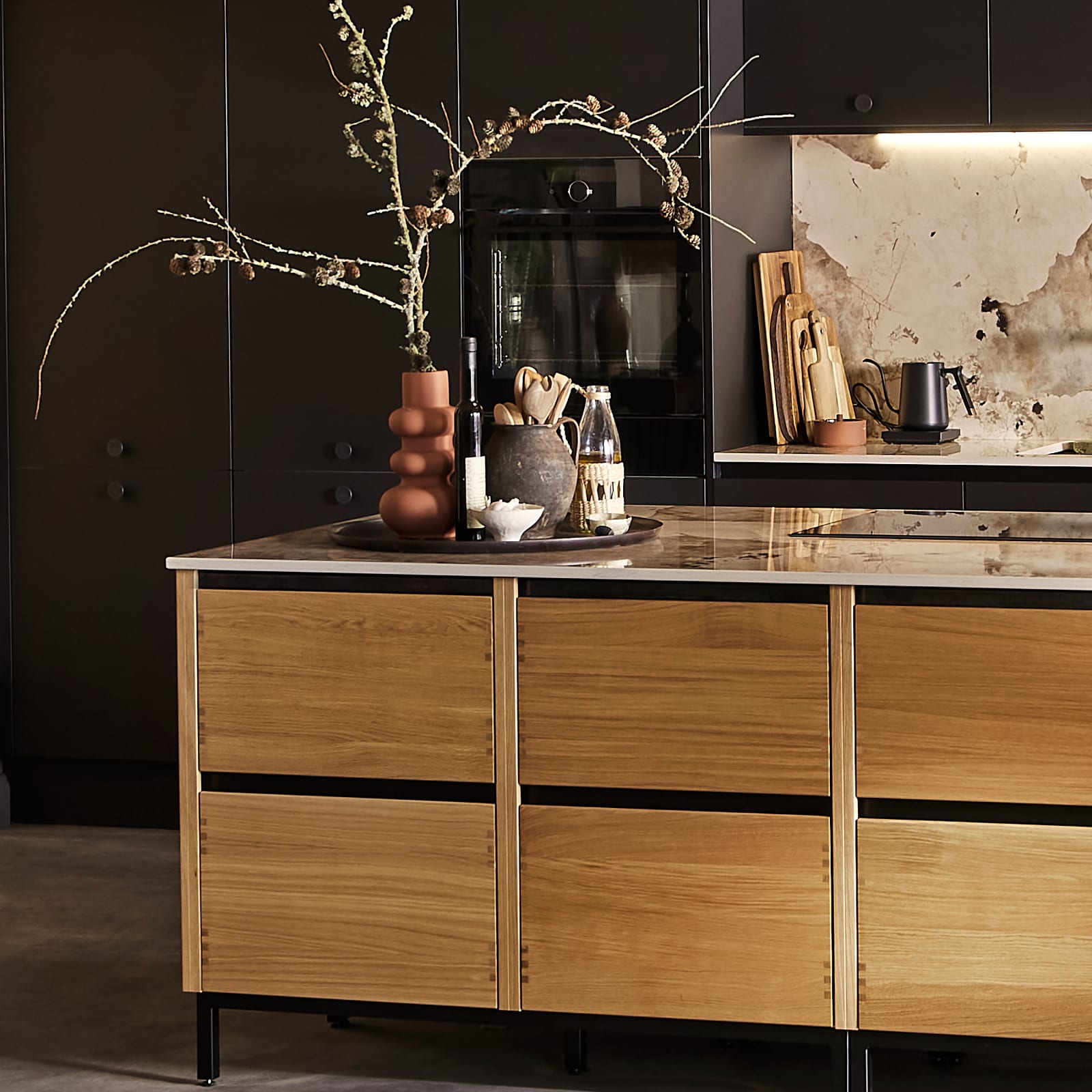 End of Nordic Craft kitchen island, with a vase holding a large branch