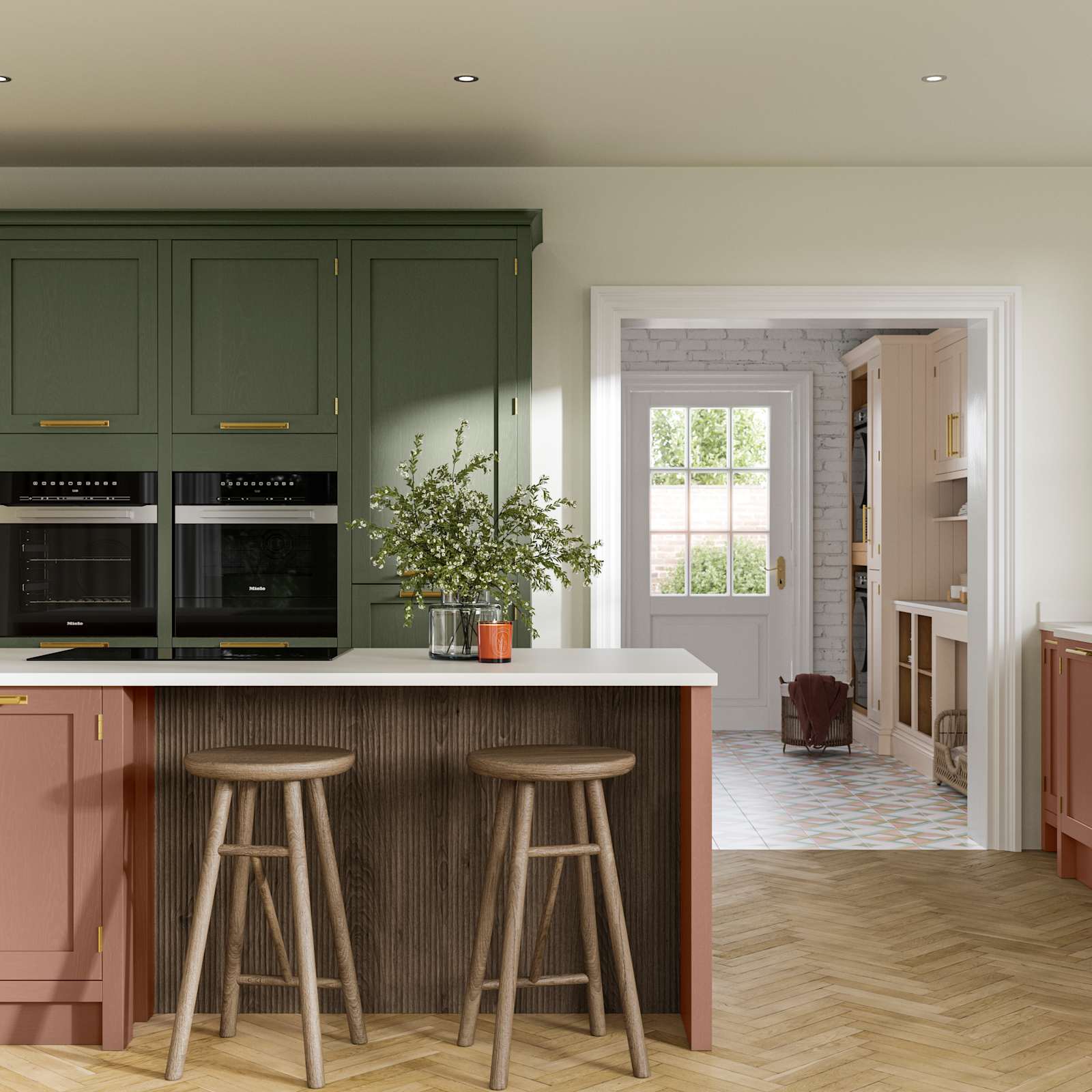 Tall Wardley kitchen cabinets  with built-in ovens, a kitchen island in shade Clay with wooden panelling by seating area and matching wooden bar stools.