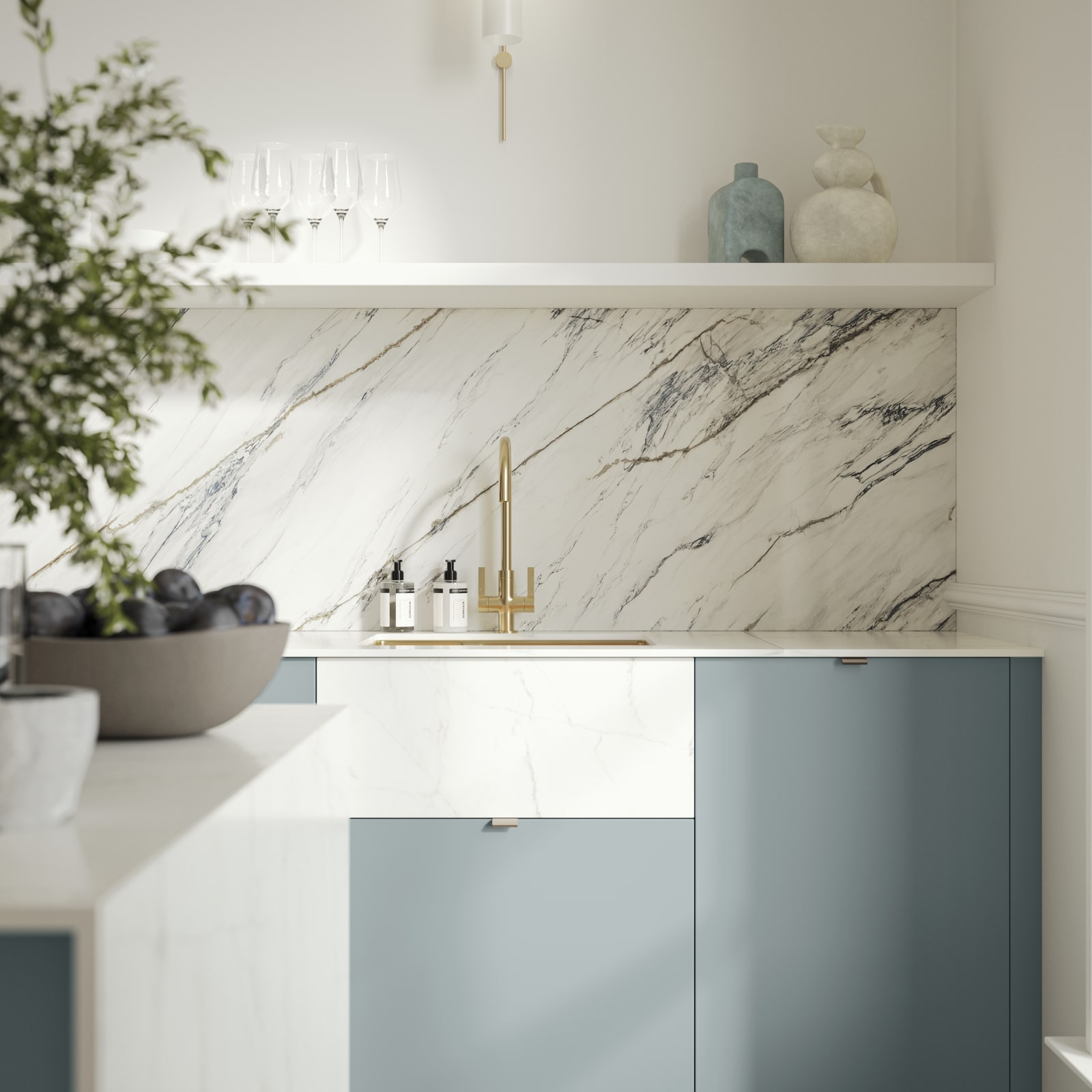 Soho Duck Blue kitchen from Magnet with white marble splashblack, paired beautifully with a bright brass tap and sink.