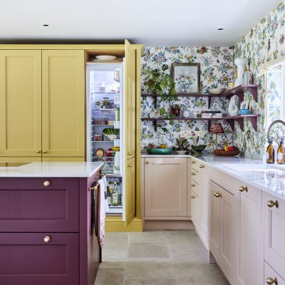 Wide image of sink, kitchen island and opened integrated Fridge. Ludlow cabinetry from Magnet in colours Burlington Red, Chalk blush and Harvest in Heritage classic with a contemporary twist.