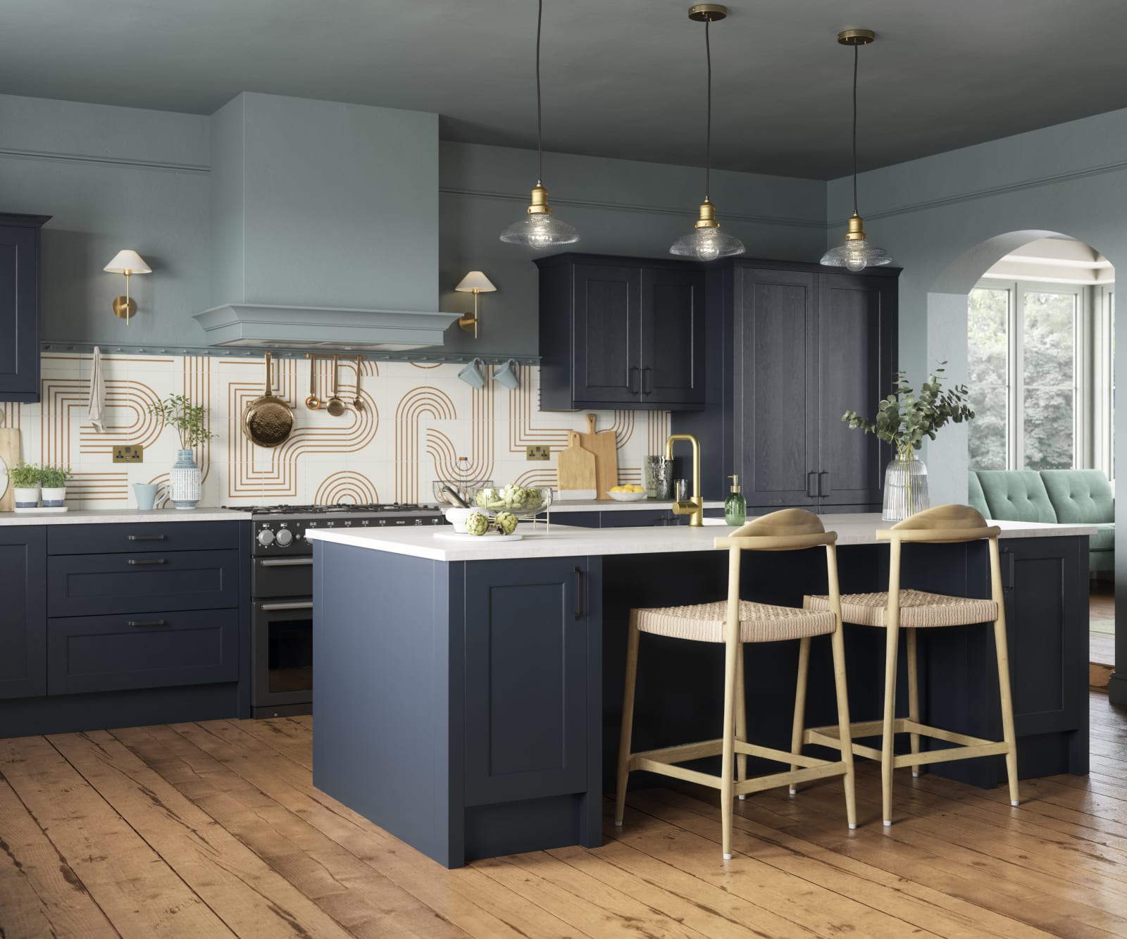 Modern country-style Ludlow kitchen in dark blue shade Midnight, with lighter blue walls, wooden floors and wooden barstools by kitchen island.