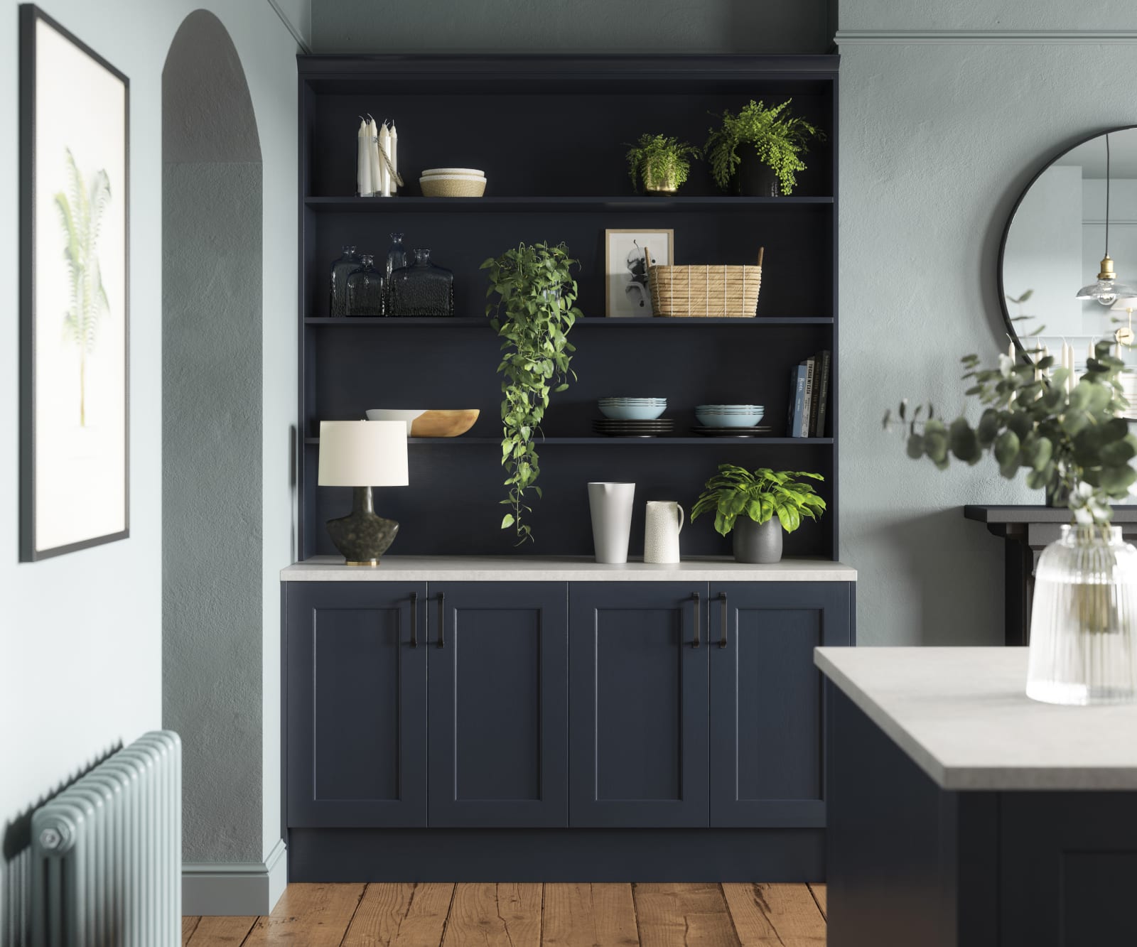 Modern country-style Ludlow Shaker kitchen in dark blue shade Midnight with matching blue open shelves and wall in open floorplan kitchen.