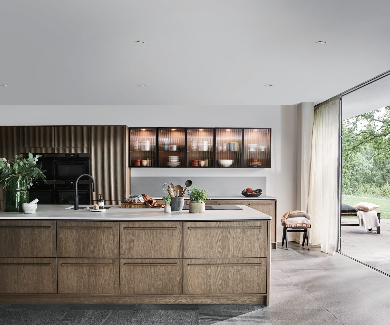 Nordic Nature. Modern wooden kitchen design with a Nordic influence. Featured floating worktops, a ribbed plinth and rounded end panels