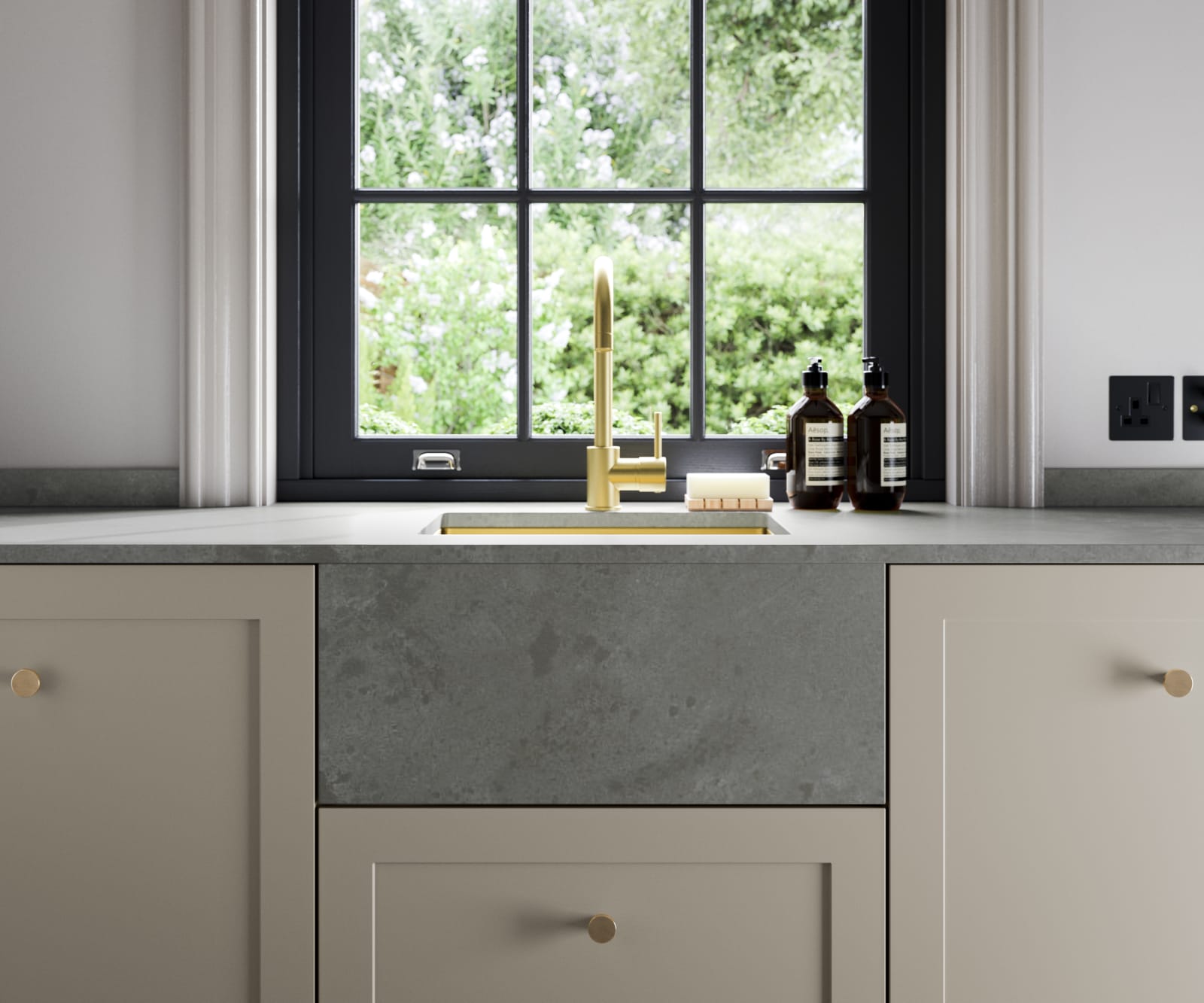 Close-up of brass tap and sink with marbled worktop with matching belfast sink, in Dunham kitchen from Magnet. Matched with brass handles.