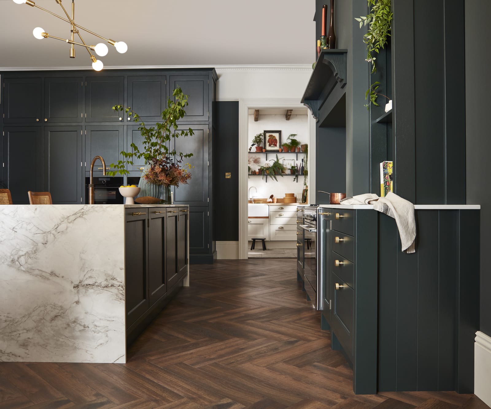 Ludlow, a traditional Shaker-style kitchen range featuring panelled doors with visible woodgrain and beading detail, in the shade Arboretum Green.