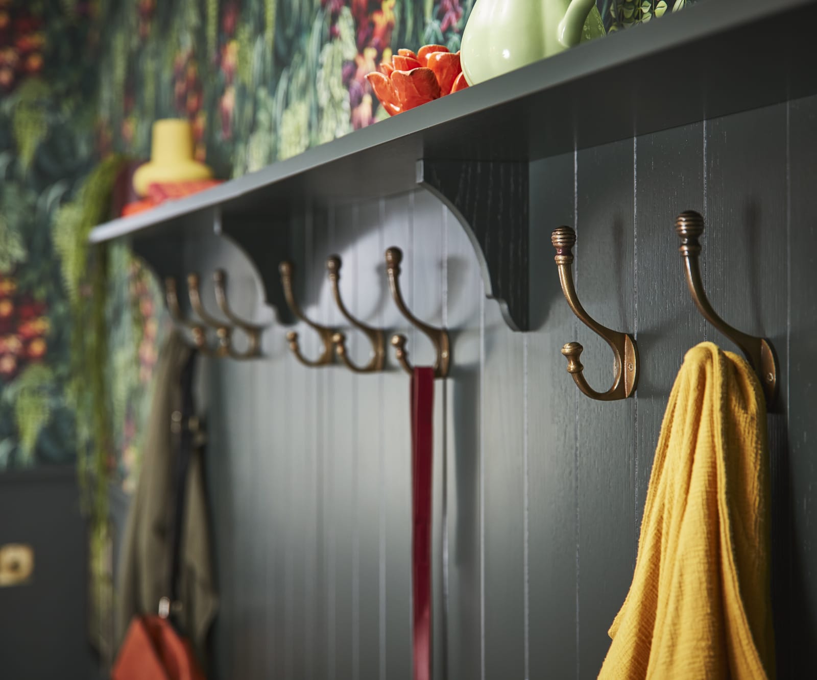 Ludlow, a traditional Shaker-style kitchen range in the shade Arboretum Green. Entrance hangers in brass