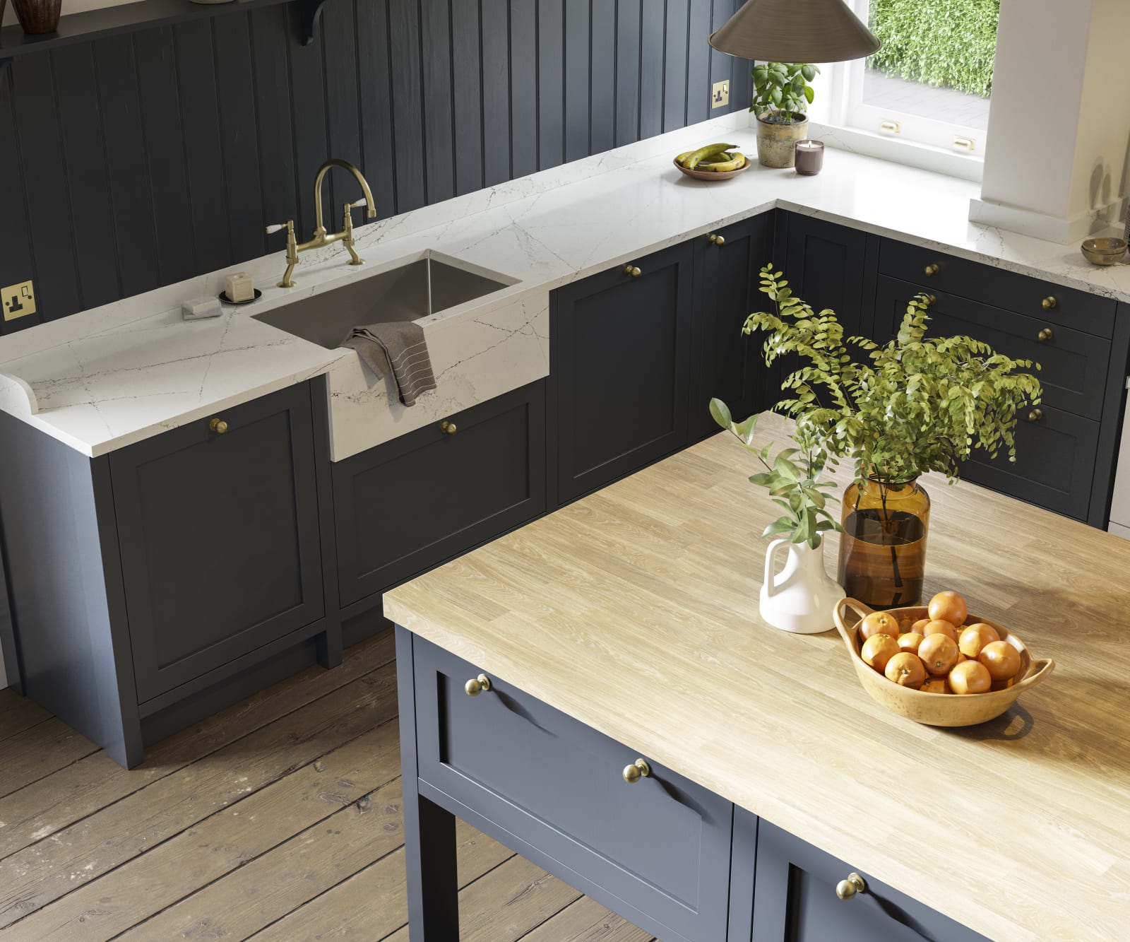 View of shaker kitchen in dark blue shade, with marble worktop and a kitchen island with light wood worktop.